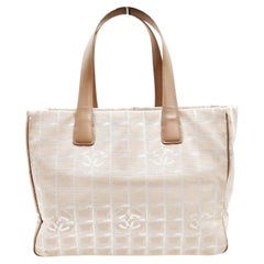 Un bolso tote de la nueva línea de viaje de Chanel 2003 de nailon beige y piel marrón