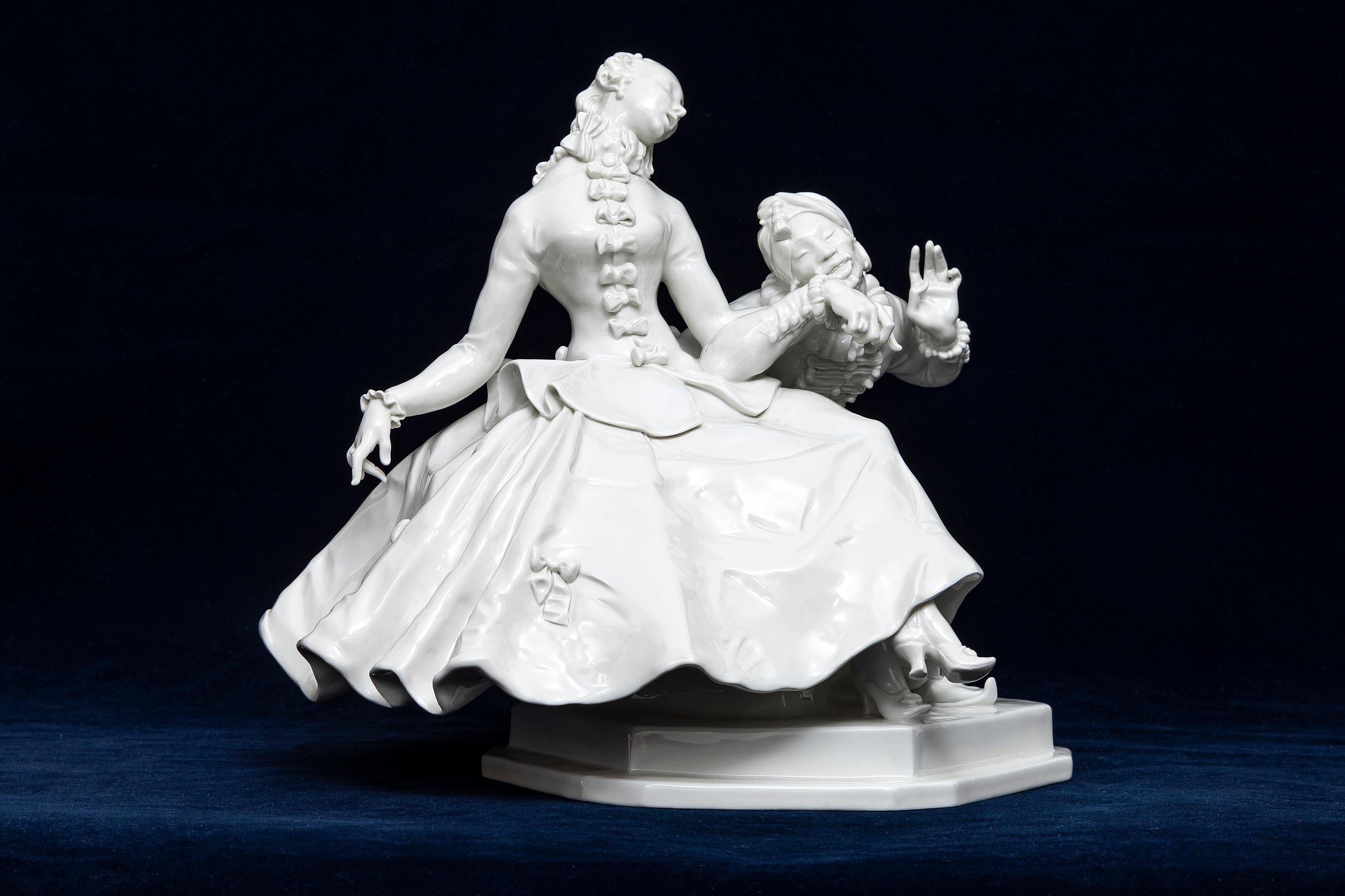 A 20th Century Meissen Blanc de Chine Porcelain Figural Couple, Lady and Man.  A finely dressed couple engages in flirtatious courtship in this early 20th-century Meissen porcelain inspired by the 18th-century Commedia dell’Arte. The work depicts a