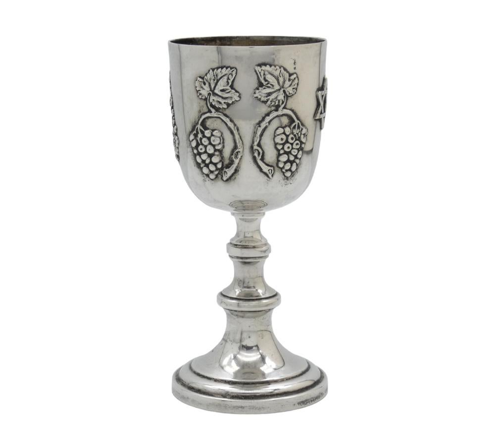 This elegant 20th-century American silver Kiddush goblet is a striking example of refined Judaica design, blending traditional Jewish symbolism with classic American silversmithing of the modern era.

The goblet stands on a circular stepped domed