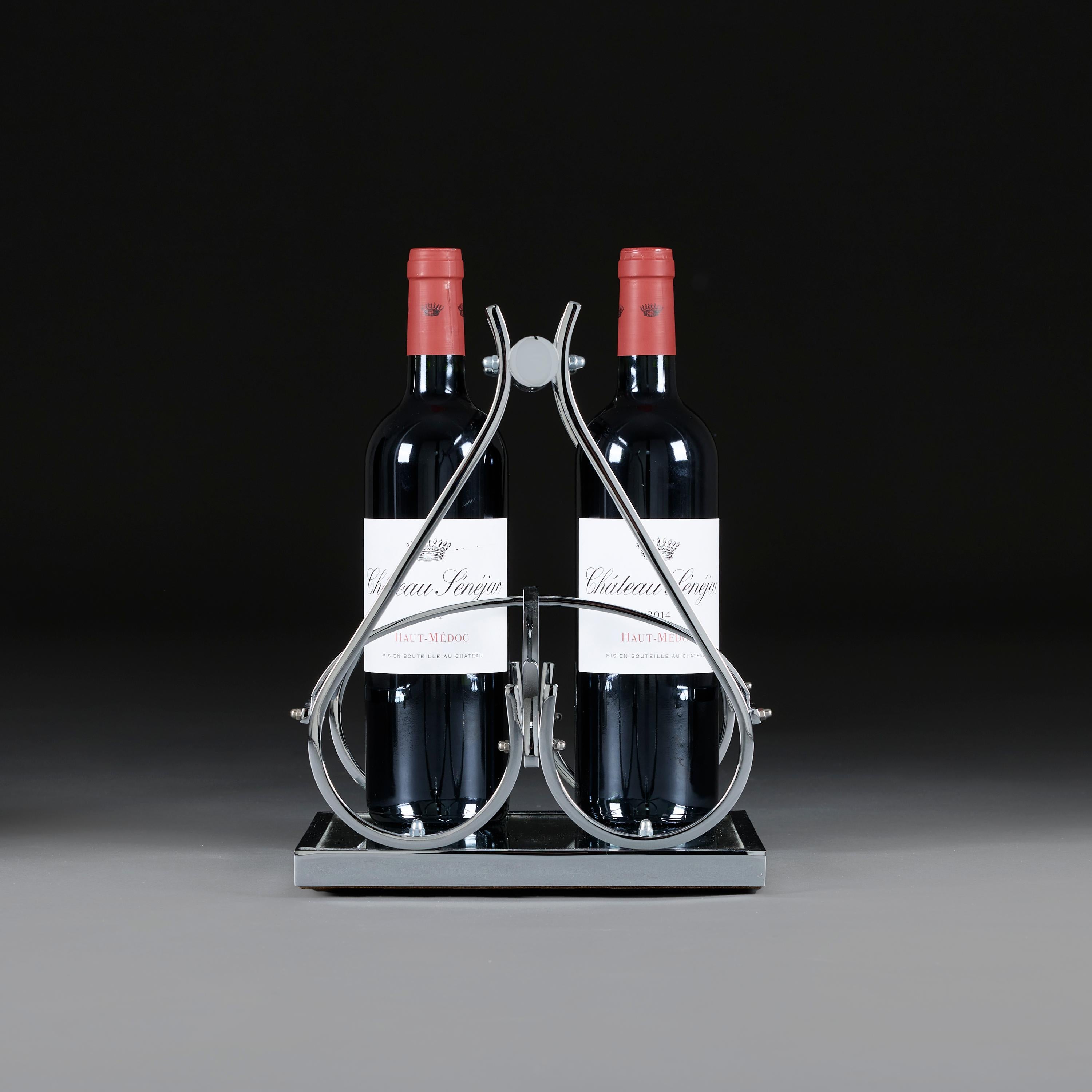 France, circa 1930

An Art Deco wine bottle carrier by Jacques Adnet, the sculptural form with curved arms and frame in chrome plate, the base inset with patinated glass, to hold four wine bottles.

Height 30.00cm

Width 23.00cm

Depth 23.00cm