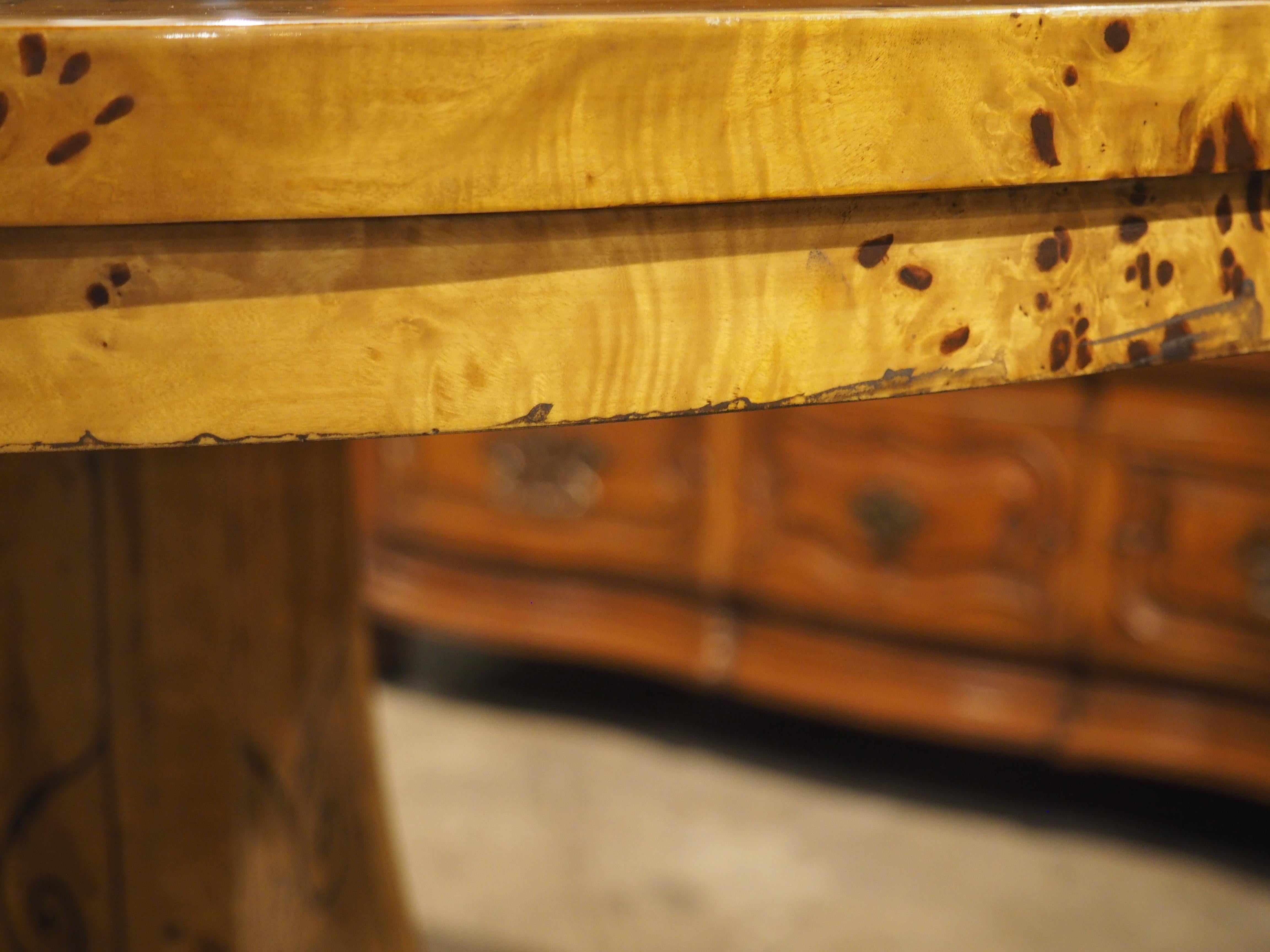 More information coming soon…

The marquetry decor of this French Charles X-style center table depicts numerous foliate margents, climbing plants, and leafy rinceaux.  Hand-carved in the 1900s, the table has a beautiful gold hue with brown marquetry.