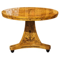 A 20th Century French Charles X Style Center Table with Marquetry Decor