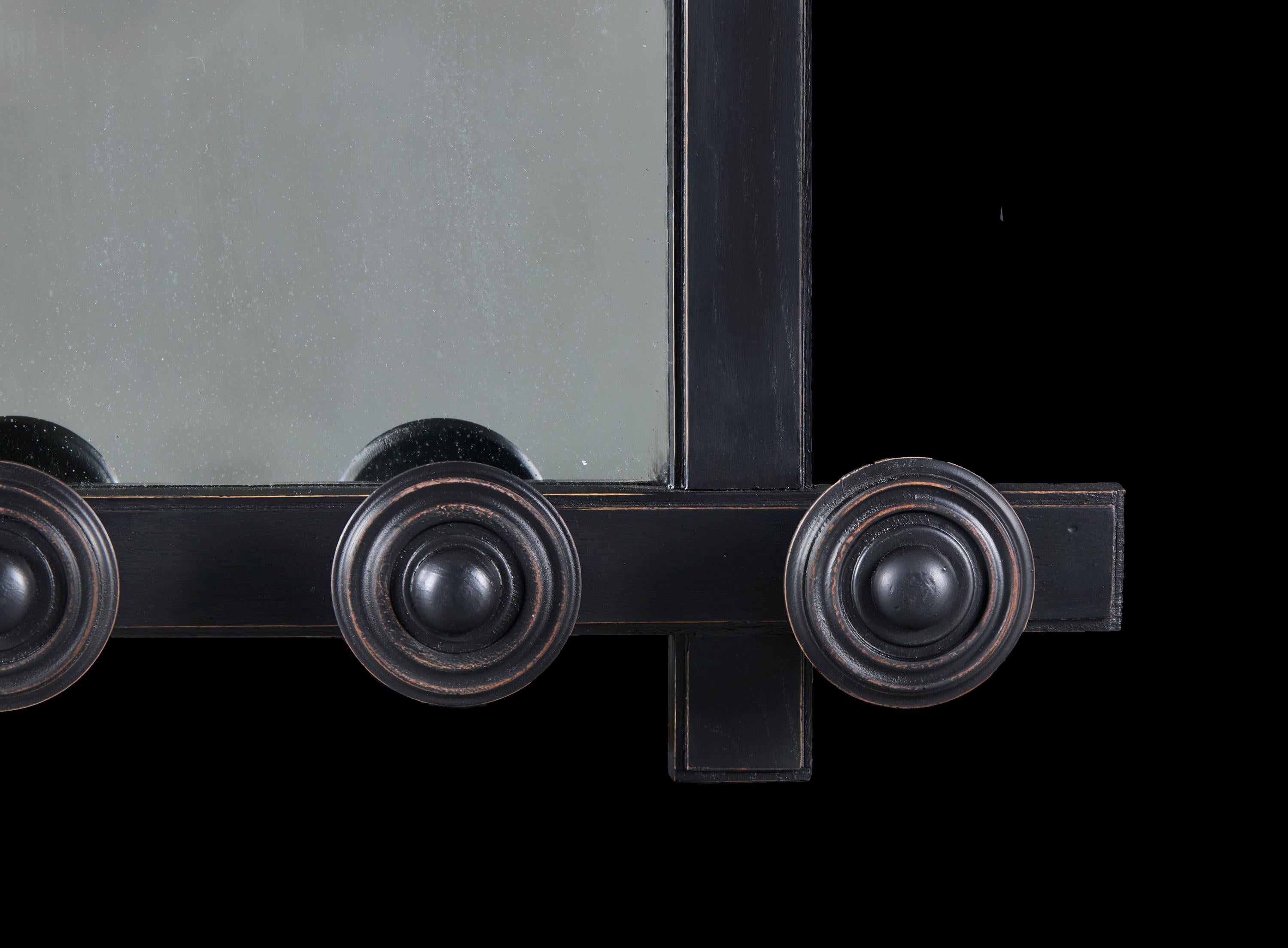 France, circa 1940

A mid-twentieth century French modernist mirror, the ebonised frame with crossed corners, and protruding roundels to the top and base.

Height 81.50 centimetres.

Width 81.50 centimetres.

Depth 11.00 centimetres.
