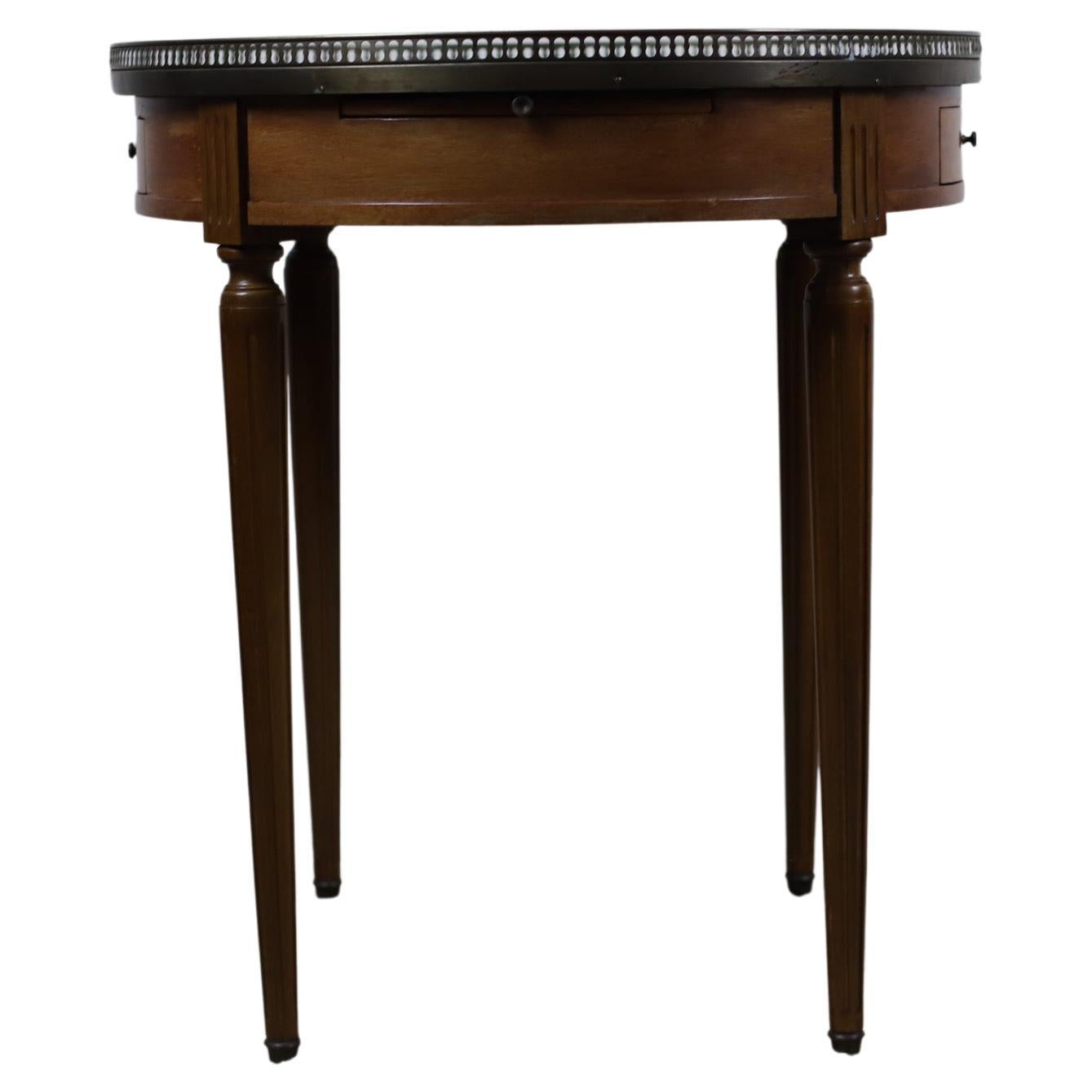 
A 20th century French walnut white marble-topped Bouillotte centre table.
Elegant Bouillotte Table in Walnut with a Grey veined White Marble, surrounded by a Gallery made of a stamped and profiled Brass band.
This piece of furniture takes its