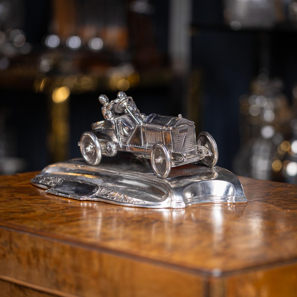 A wonderful 20th Century German novelty silver plated inkwell in the shape of a vintage racing car going down the mountain. The inkwell is very cleverly designed, underneath the bonnet (hood) there are two removable reservoirs for ink, underneath