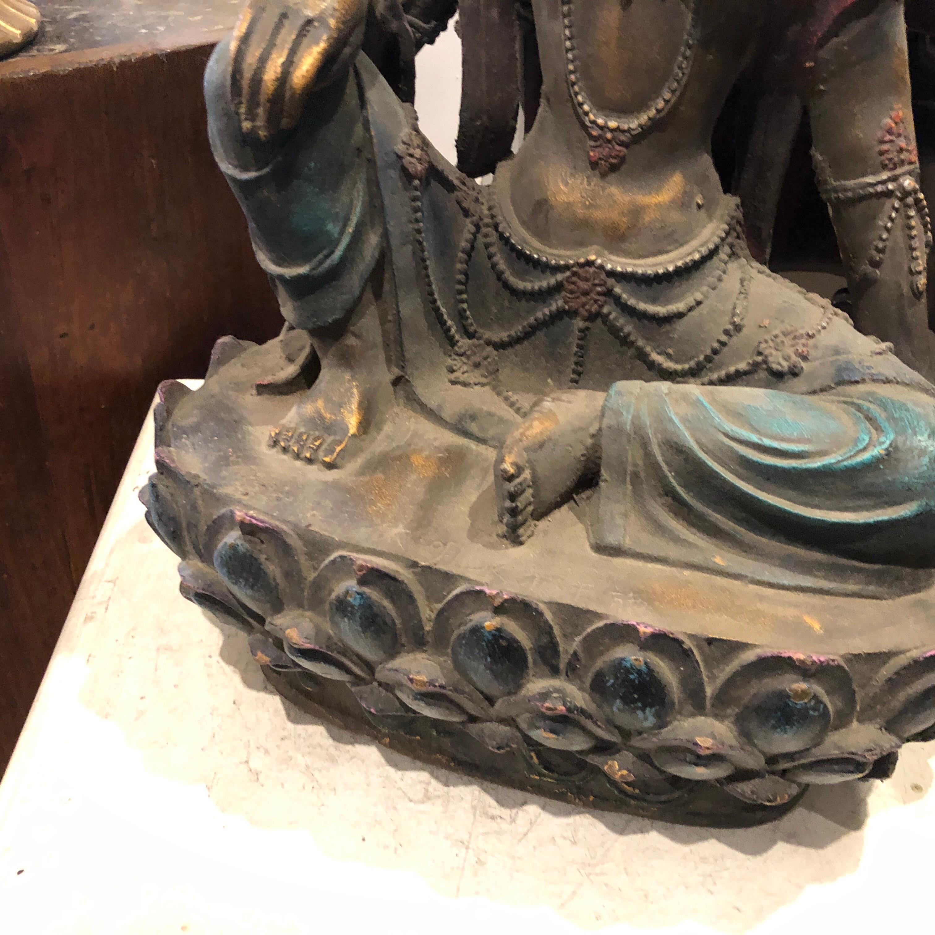 A cast iron and bronze hand-painted statue made in China in the 20th century, good conditions overall, signs of the age.