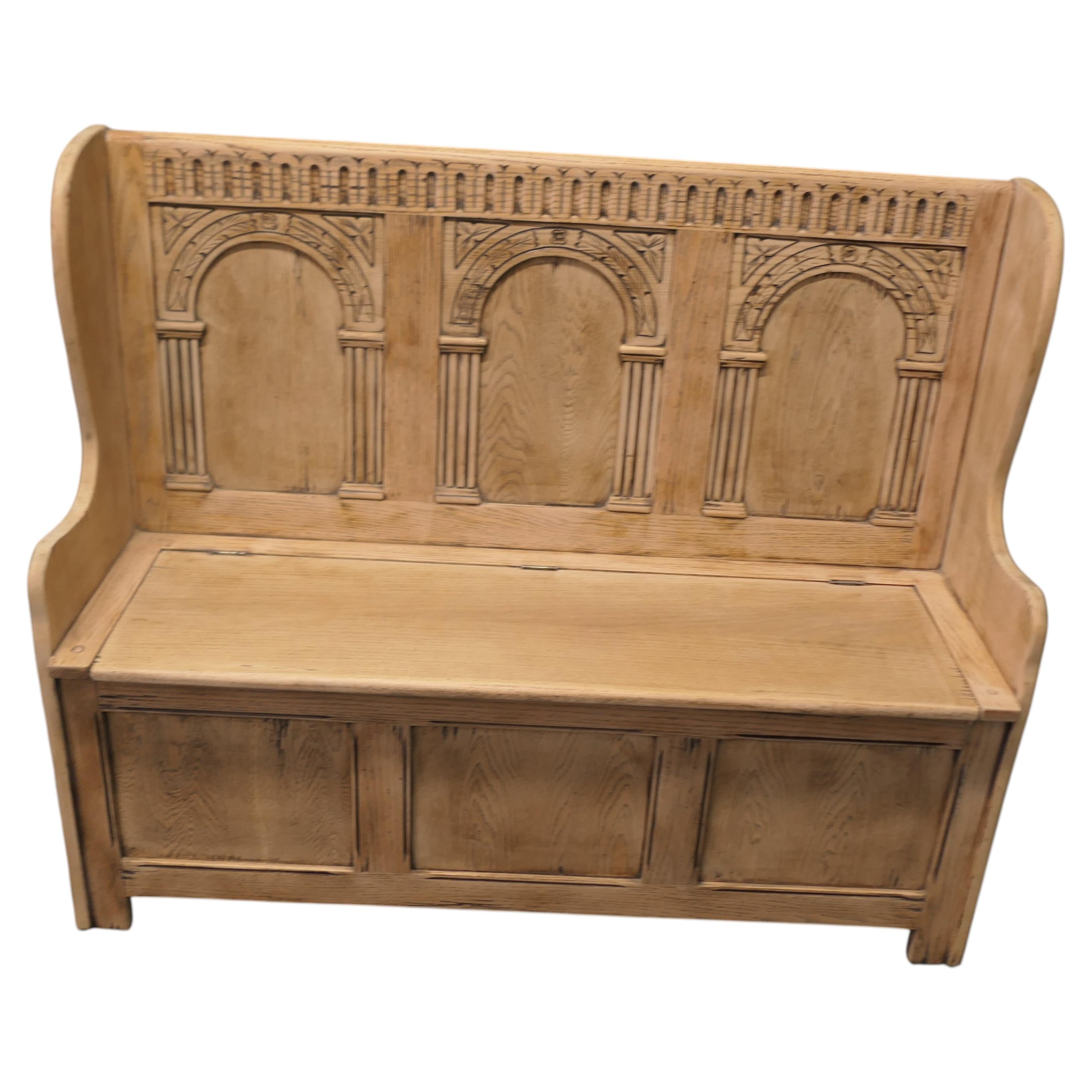 A 20th Century High Back Oak Box Settle The Settle has 3 carved back panels For Sale