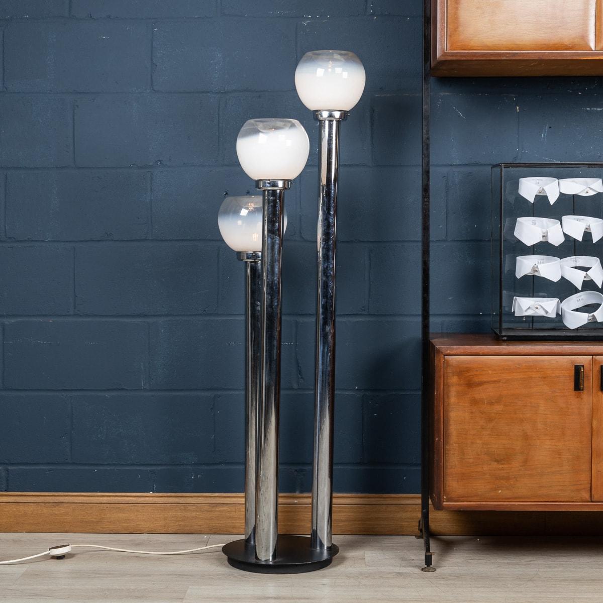 A vintage Italian floor lamp with five lights attributable to Carlo Nason. A beautiful chromed steel structure supports three hand blown Murano glass shades made by Mazzega, dating to the late 1960s, early 1970s. Each shade is beautifully shaped