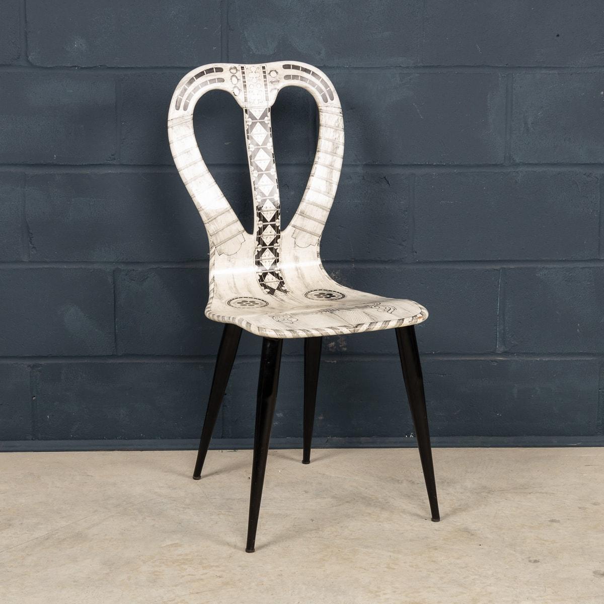 A very rare chair by Fornasetti Studios made in Italy towards the latter end of the 20th century. These chairs are handcrafted using the original artisan techniques. It is silk-screened by hand, hand painted and covered with a smooth lacquer. This