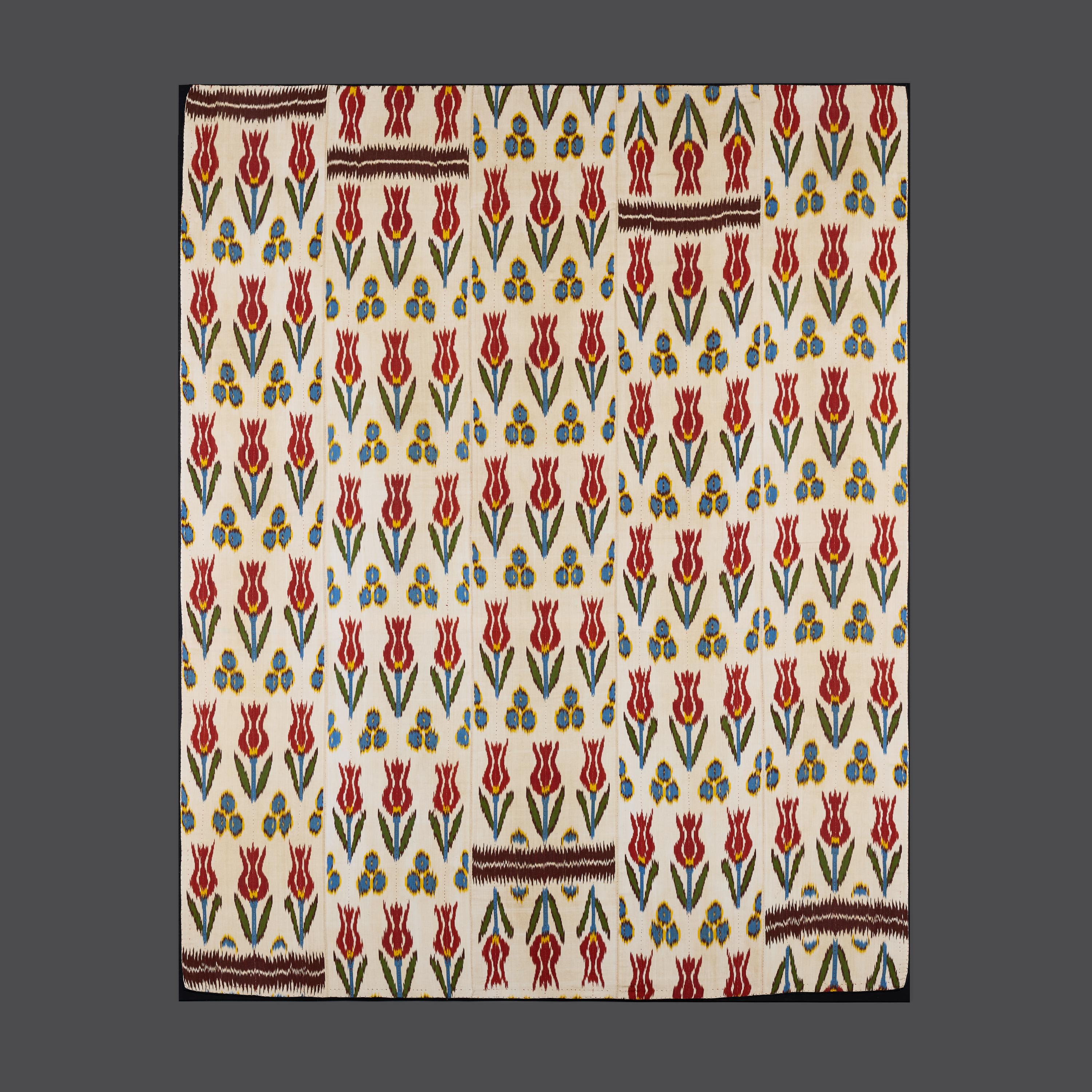 Uzbekistan, circa 1920

An unusual early twentieth century large ikat panel with repeating bands of stylised tulips decorated in reds yellows blues and greens, with aubergine panels of flame stitch intermittently spaced, now mounted on a