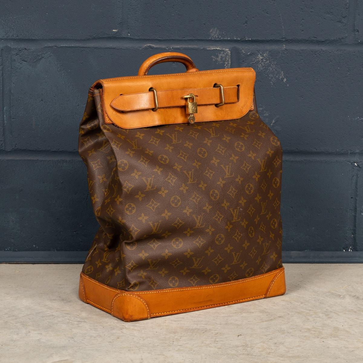 A late-20th Century Louis Vuitton steamer travel bag in monogram canvas and natural tan leather, made in France. Steamer bags have been produced by Louis Vuitton for over 120 years. In 1901, the company introduced the simple canvas and leather