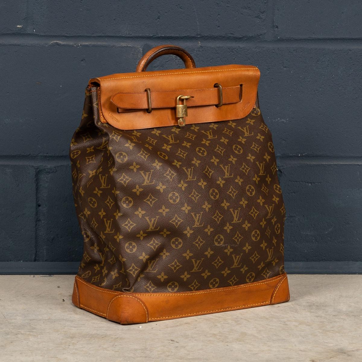 A late-20th Century Louis Vuitton steamer travel bag in monogram canvas and natural tan leather, made in France. Steamer bags have been produced by Louis Vuitton for over 120 years. In 1901, the company introduced the simple canvas and leather