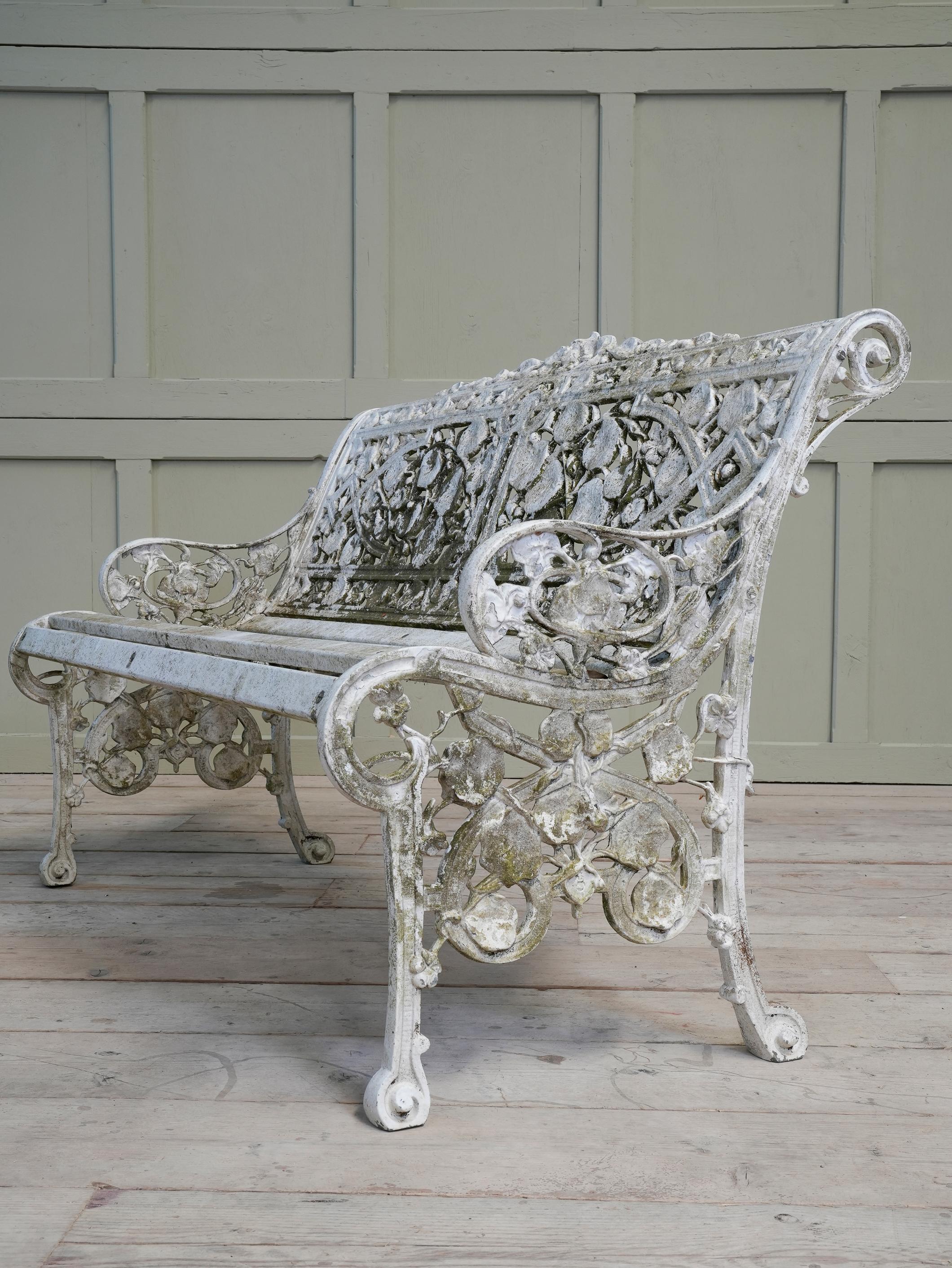 A cast alloy garden seat after the original 19th century Coalbrookdale 