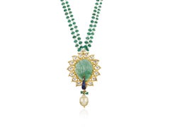 A 22K Indian emerald and polki peacock inspired pendant with meenakari (enamel)