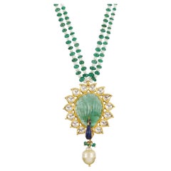 A 22K Indian emerald and polki peacock inspired pendant with meenakari (enamel)