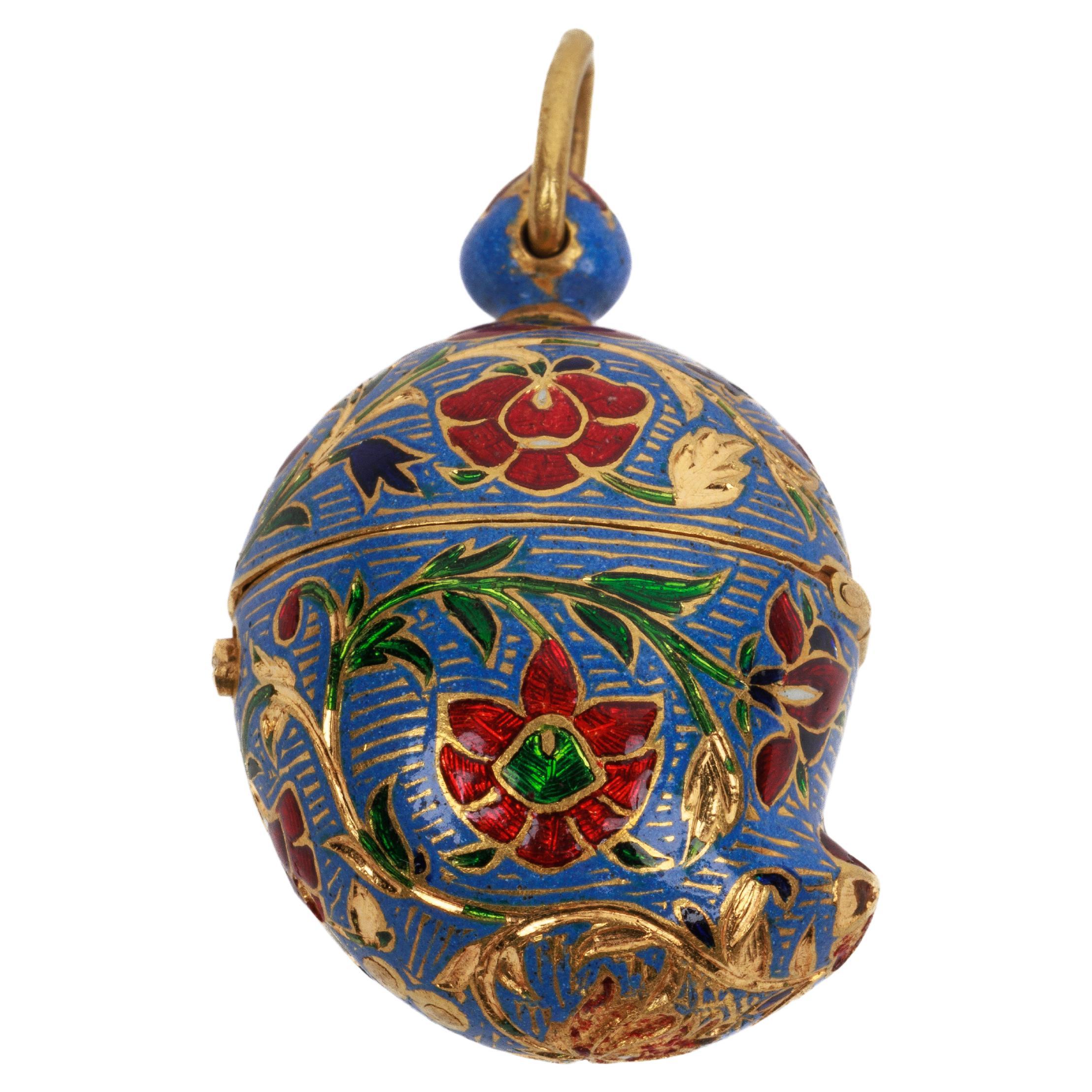 A 22K Indian Gold and Enamel Mango Shaped Pendant, Jaipur, 19th Century.

Finley enameled with green, red, and blue enamel throughout, decorated with flowers on lavender ground. With hinged lid for opening. A unique piece.

This pendant may have