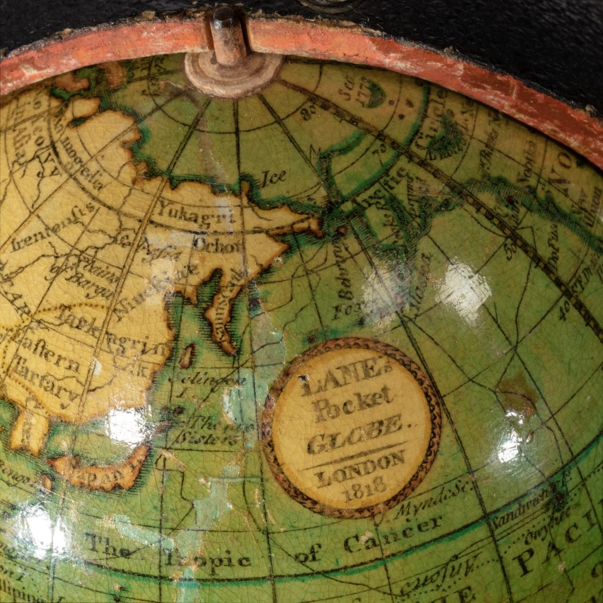 A 3 ½ inch Regency Lane’s pocket globe, dated 1818, the terrestrial globe with the seas in light green and the land masses outlined in darker green, contained within a hinged black shagreen case, the concave interior of the case applied with the