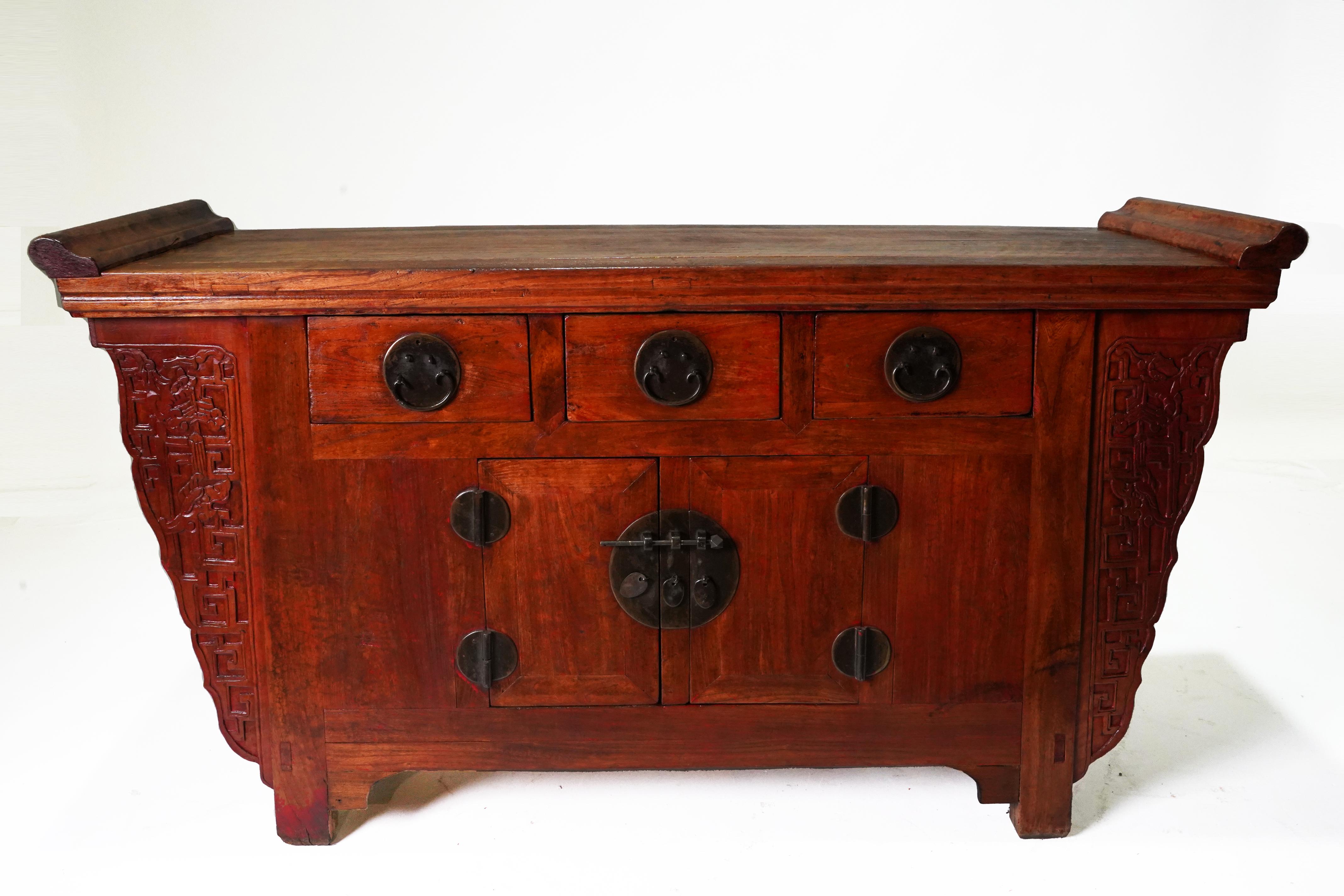 This is a classic example of a “Beijing” or Tianjin” sideboard, so-called because of their origin in this region of northeastern China. This compact chest has three drawers with two doors below. The center stile between the doors can be removed to