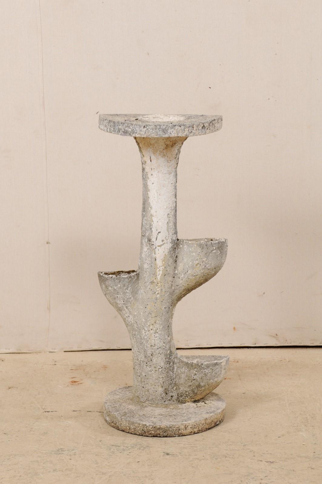A French garden foliage inspired and tiered sculptural shelf from the mid-20th century. This vintage cast-stone garden or patio decoration from France features a rounded base which supports a foliage inspired shaped sculpture, topped with a