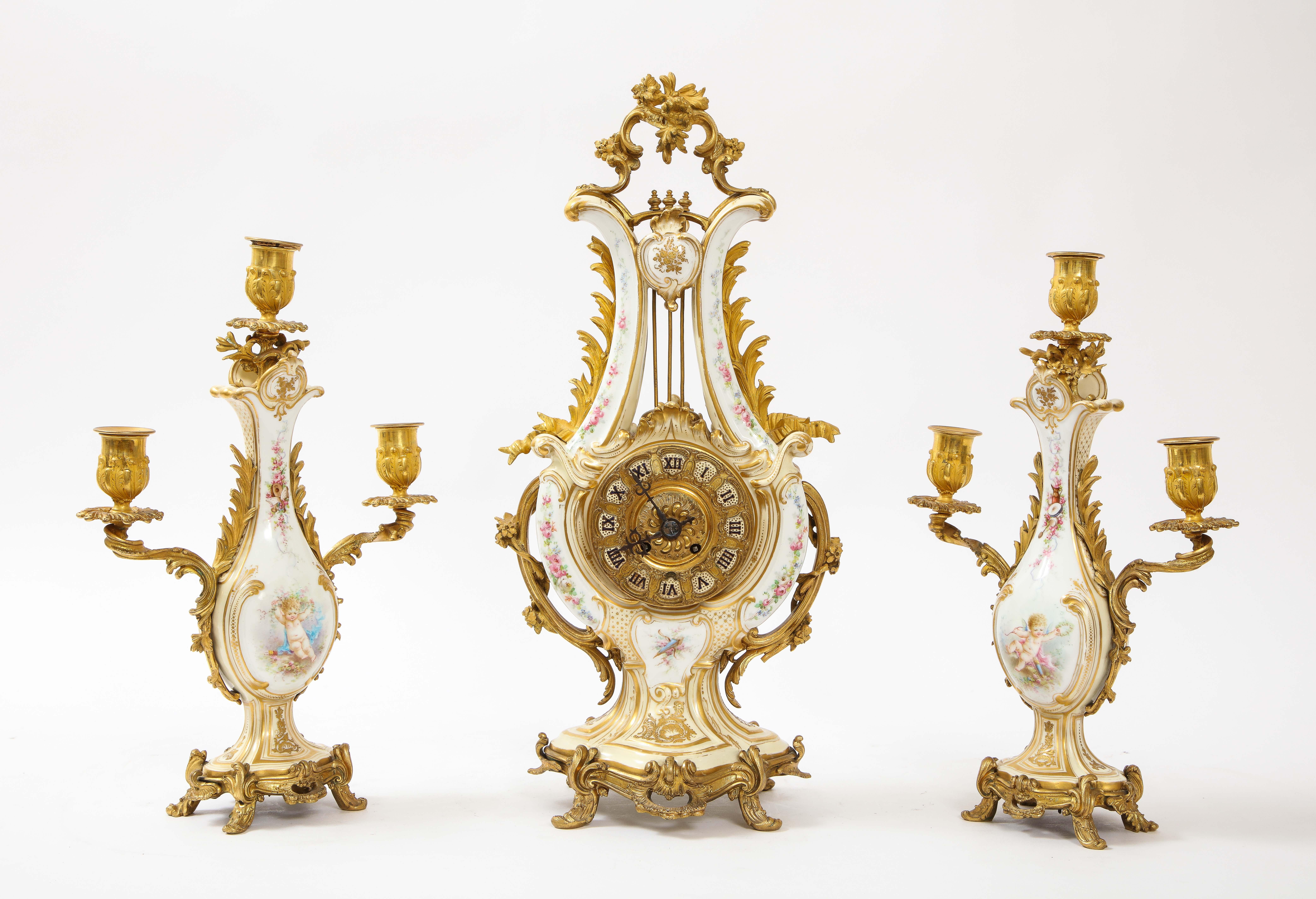 A gorgeous and very unusual 19th century French dore bronze mounted Sevres white porcelain three-piece clock and three-light candelabra garniture set. The Lyre shaped clock and candelabras are beautifully made with the finest French Sevres white