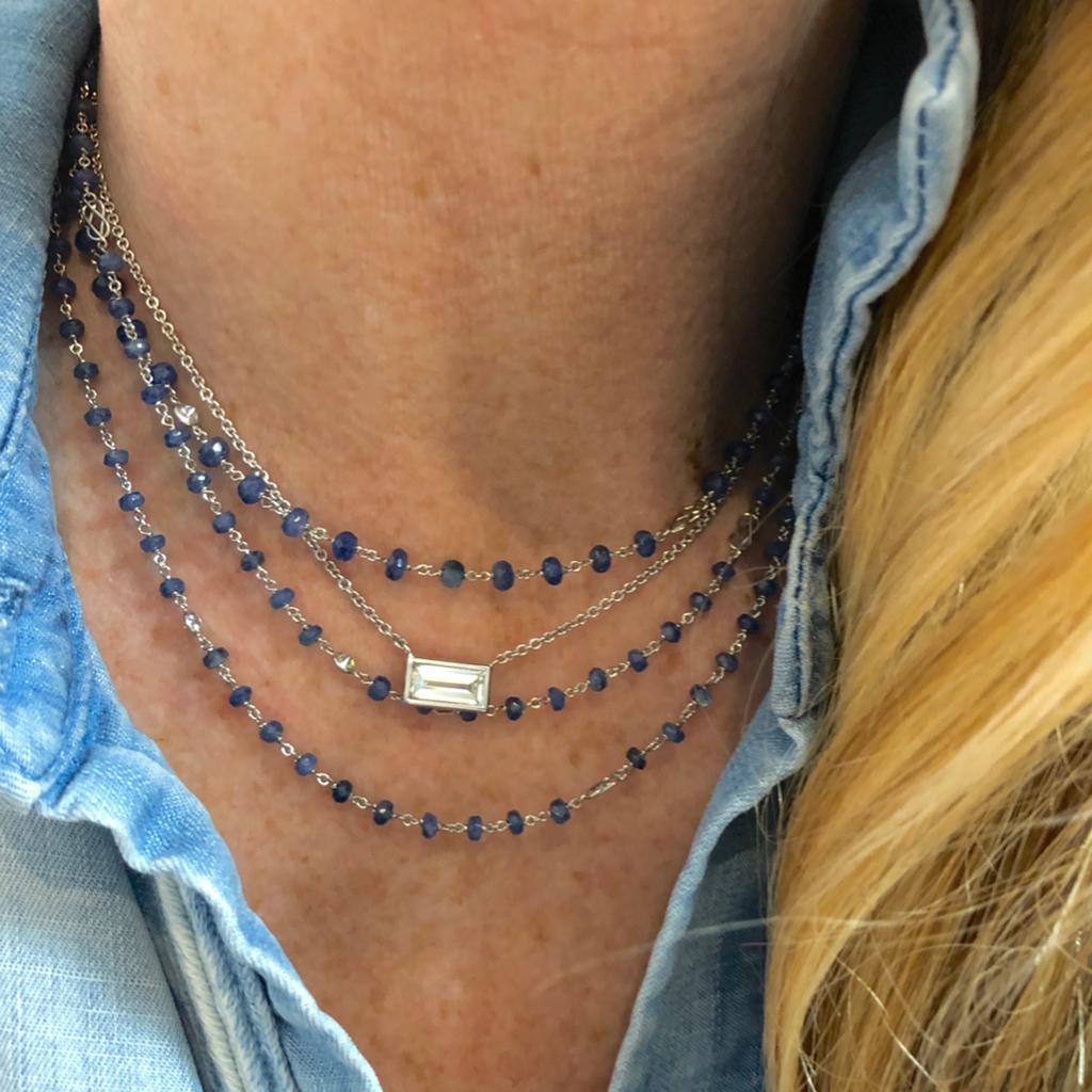 A lavish 48” long hand made Platinum blue sapphires and diamonds station necklace. The sapphire beads are faceted and have an estimated weight of 49,95 carats. The sapphire beads alternate with 1.20 carats of bezeled set round diamonds, GH color and
