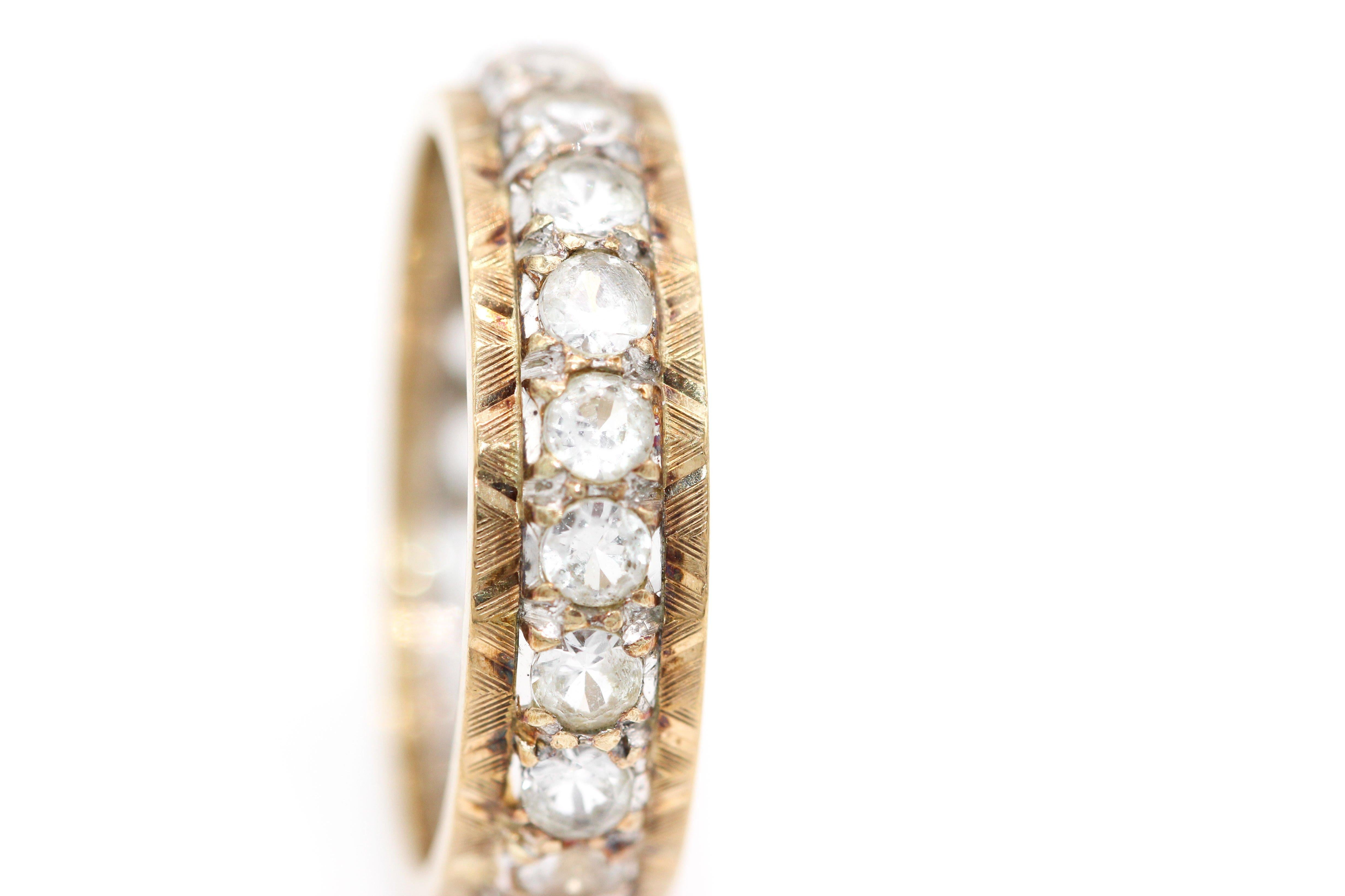 A beautiful vintage yellow and white gold diamond eternity ring. The 22 old cut diamonds set in white gold and with engraved yellow gold shoulders. 
Size   UK  Q.  
          USA   8.0

Width of band 6mm.
Hallmarked 9Kt  Birmingham UK   1964-65