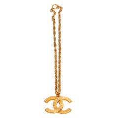 A '93 Vintage Chanel Gold-Toned Logo Pendant Necklace