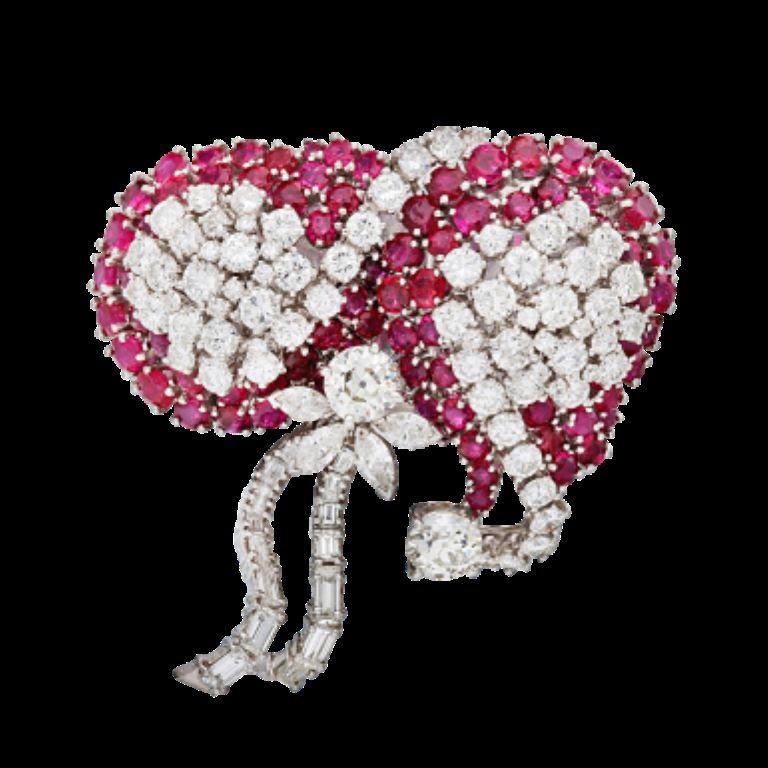 Featuring 95 diamonds and 82 rubies.
 - Diamonds weighing a total of approximately 9.70 carats
 - Rubies weighing a total of approximately 10.00 carats
 - Length 2 inches, width 2 inches
 - Platinum 
- Total weight 33.05 grams