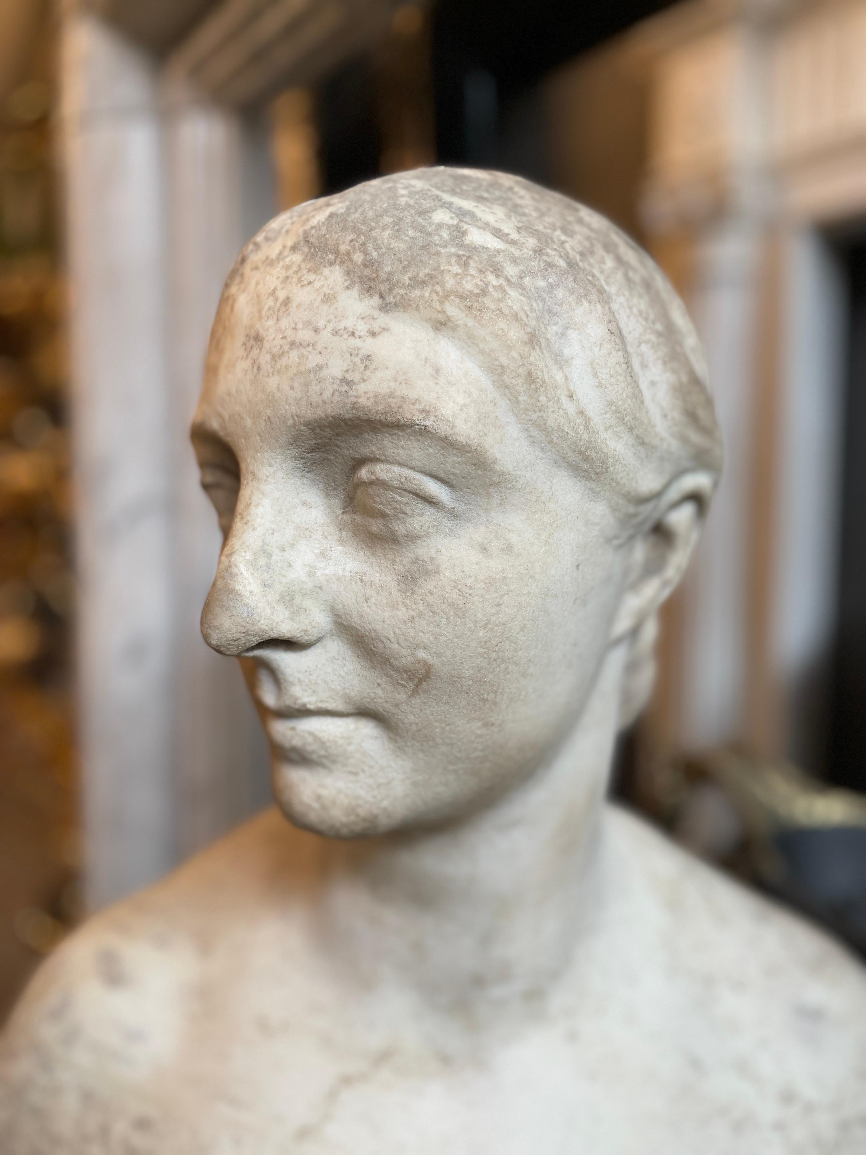A Classical bust of female form with naked shoulders, draped robe exposing one breast, her hair tied back. Mounted on Socle pedestal 

By William Behnes circa 1840-50

Born in London, Behnes was the son of a Hanoverian piano-maker and his English