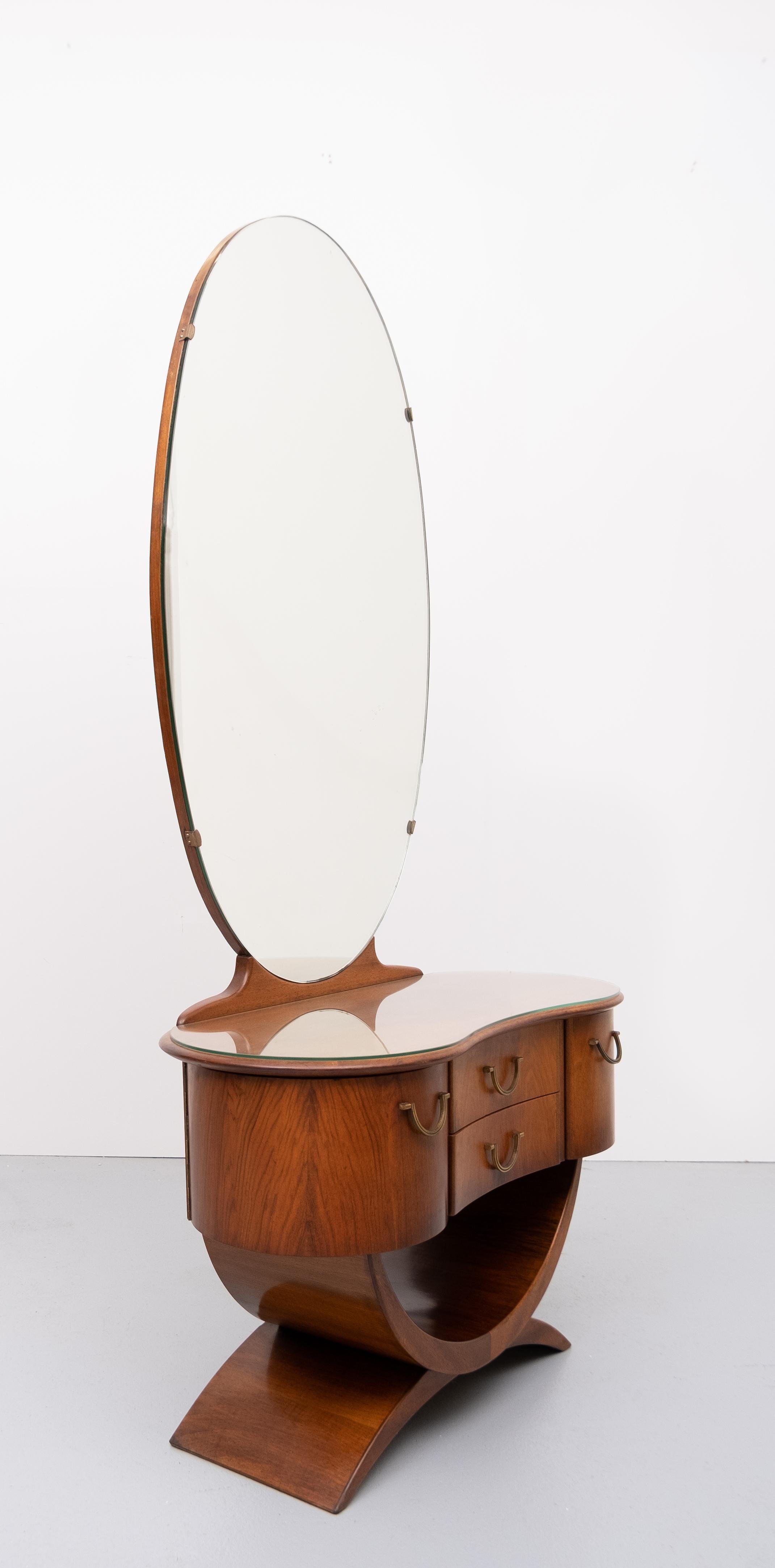 Love this vanity by A A Patijn for Zijlstra Joure Holland 1950s All these curves . very nice warm Nutwood color .Two curved anti dust drawers beautiful bronze handles. Glass plate on top. Good condition. 
Comes with the original stool. Needs to be