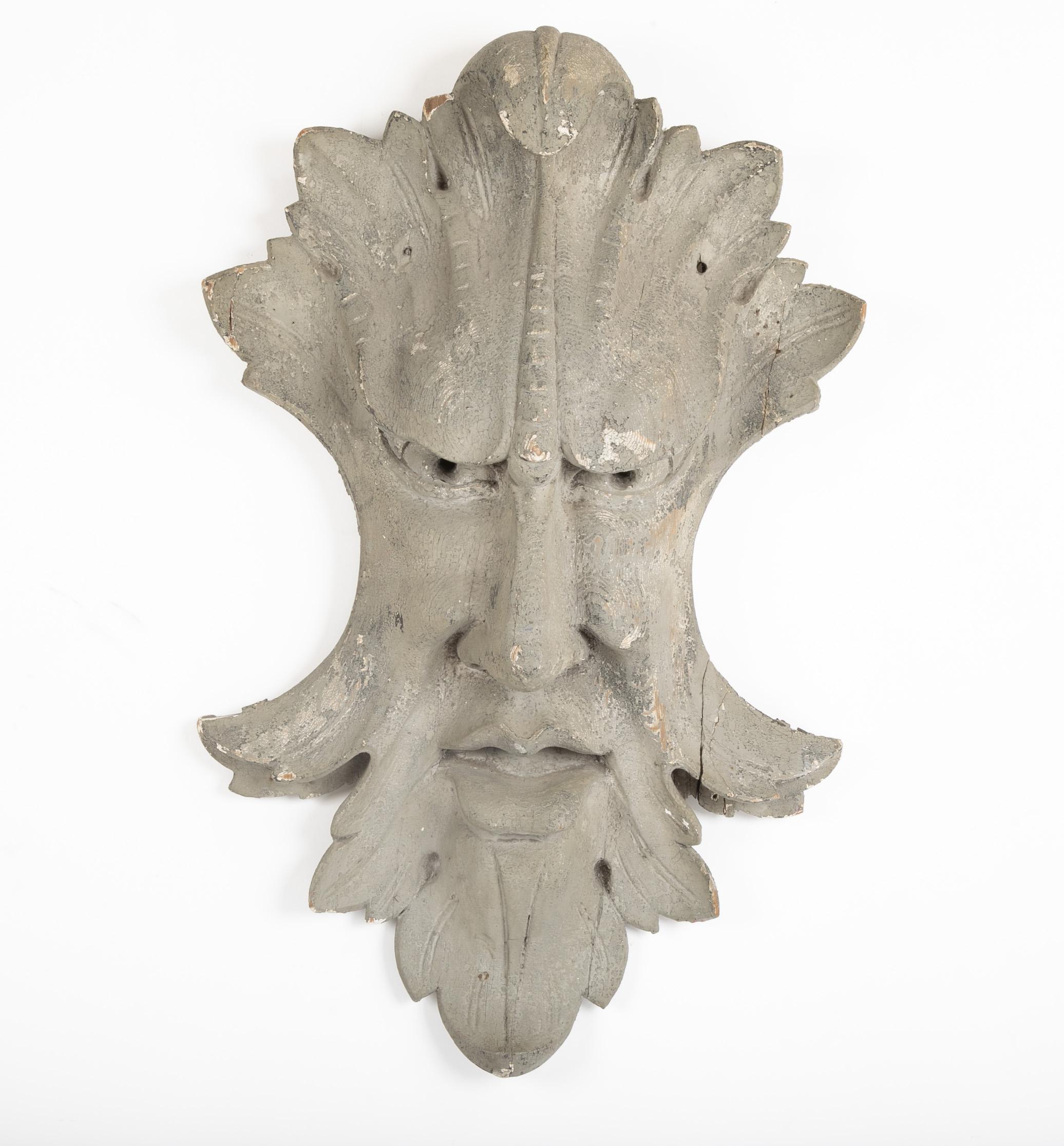 An architectural element featuring an Acanthus leaf surrounding a face.