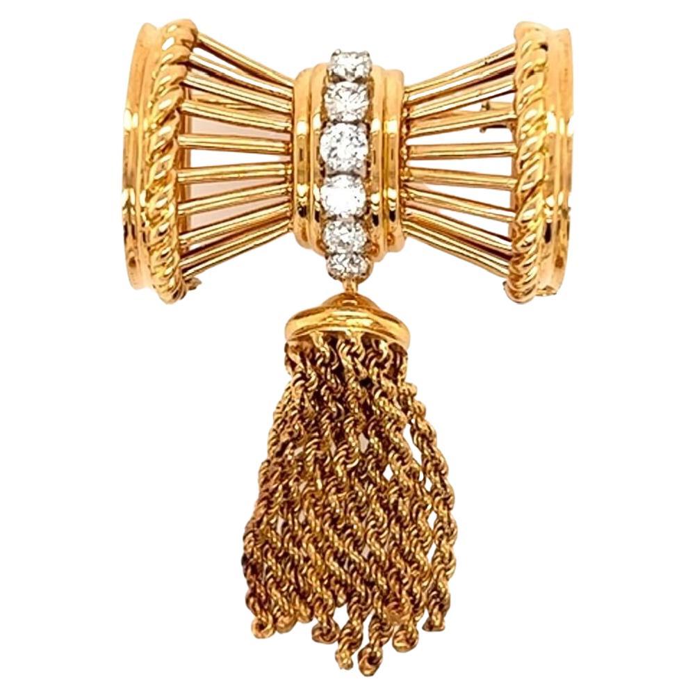 A. AUCOC Yellow gold and Diamond Tassel Brooch.