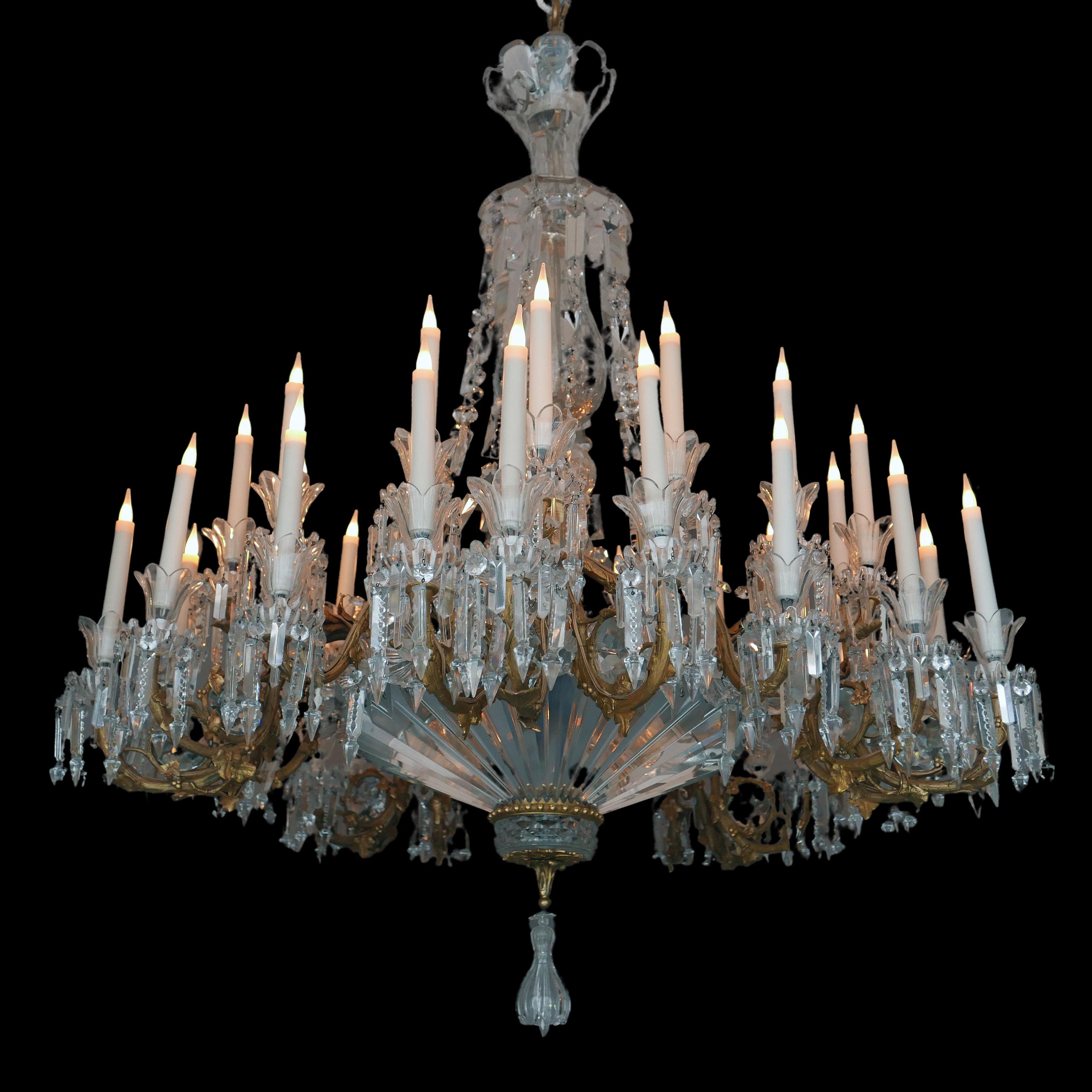 A very important thirty-five lights crystal and gilded bronze chandelier. The centered stem is made up of baluster-and-bowl-shaped cut-crystal pieces, all of very high-standard quality. Adorned with an elegant gilt bronze mount forming the