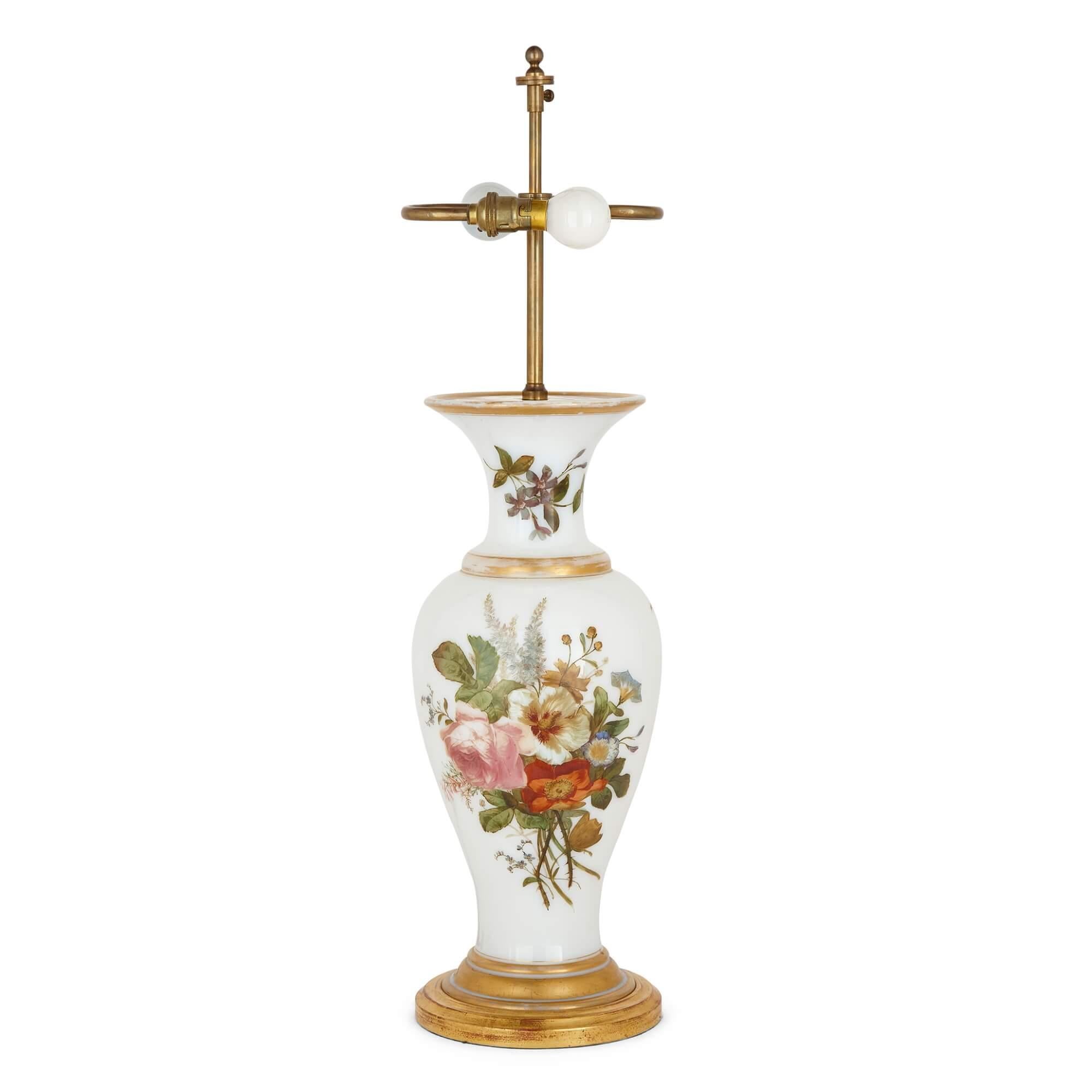 A Baccarat opaline glass lamp, vase formed with floral decoration
French, 19th century
Measures: Lamp: height 74cm, diameter 19cm
Shade: height 27cm, diameter 47cm
Height 44.5cm (excluding lamp fitting)

Originally by Baccarat, this delightful