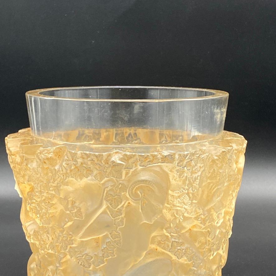 The Bacchus vase is designed by Marc Lalique for his father René Lalique in 1938 in white glass only.

It is an iconic design of the late 30tys inspired by Cocteau.

This piece has a Sienna patina and is in excellent condition.

The signature