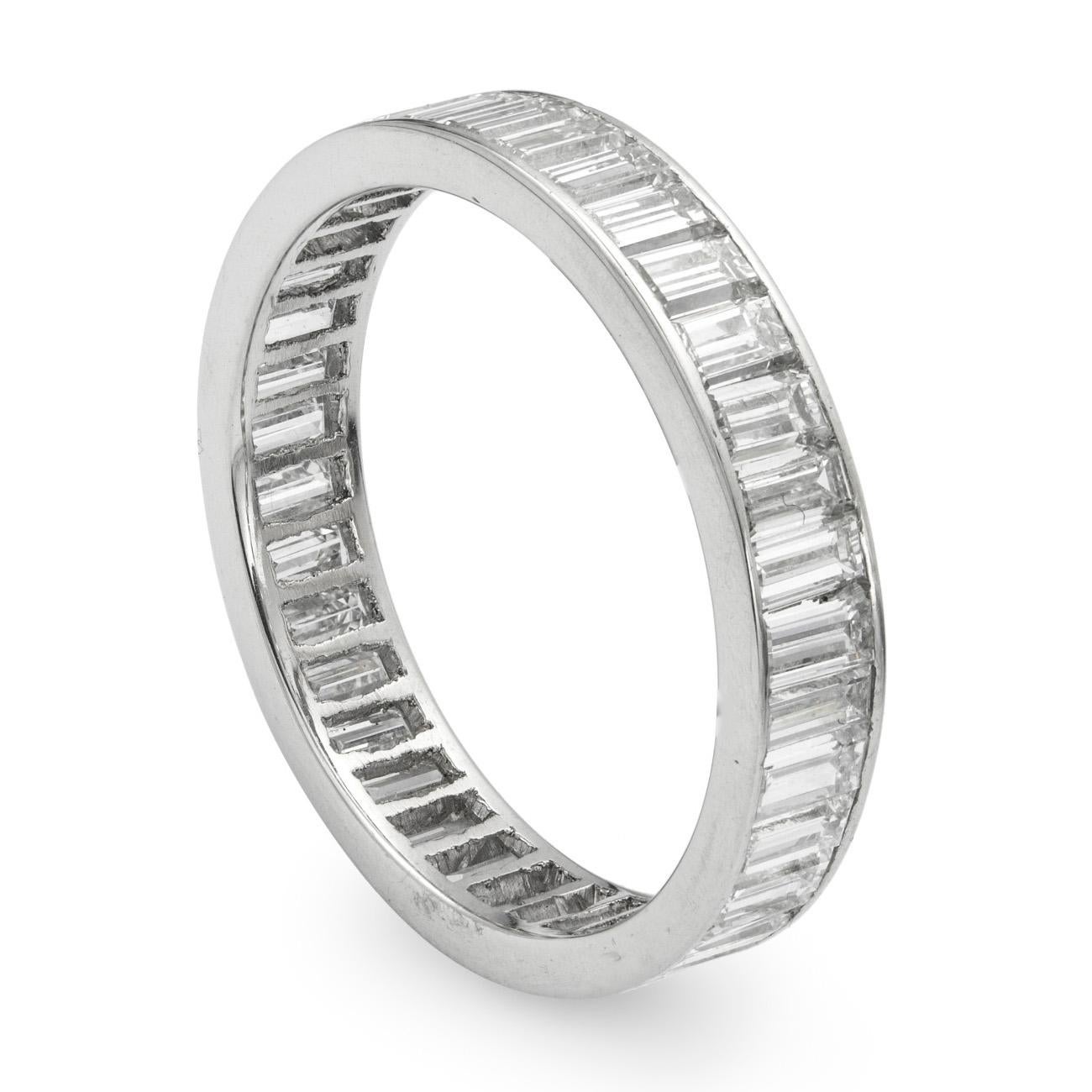 A diamond full eternity ring, the ring channel-set throughout with thirty-seven baguette-cut diamonds estimated to weigh a total of 2.50 carats, hallmarked platinum, London 2016, bearing the Bentley & Skinner sponsor mark,  finger size N, gross