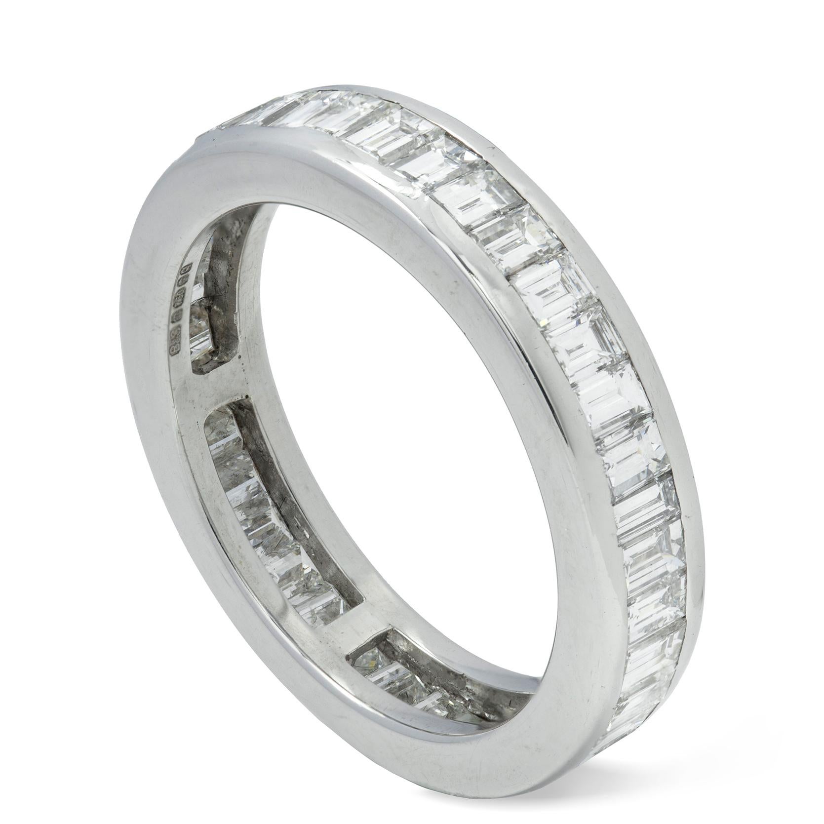 A baguette-cut diamond full eternity ring, the thirty eight baguette-cut diamonds estimated to weigh a total of 3.4 carats, channel set in white gold mount, hallmarked 18ct gold London 2015, bearing the Bentley and Skinner sponsor mark, finger size