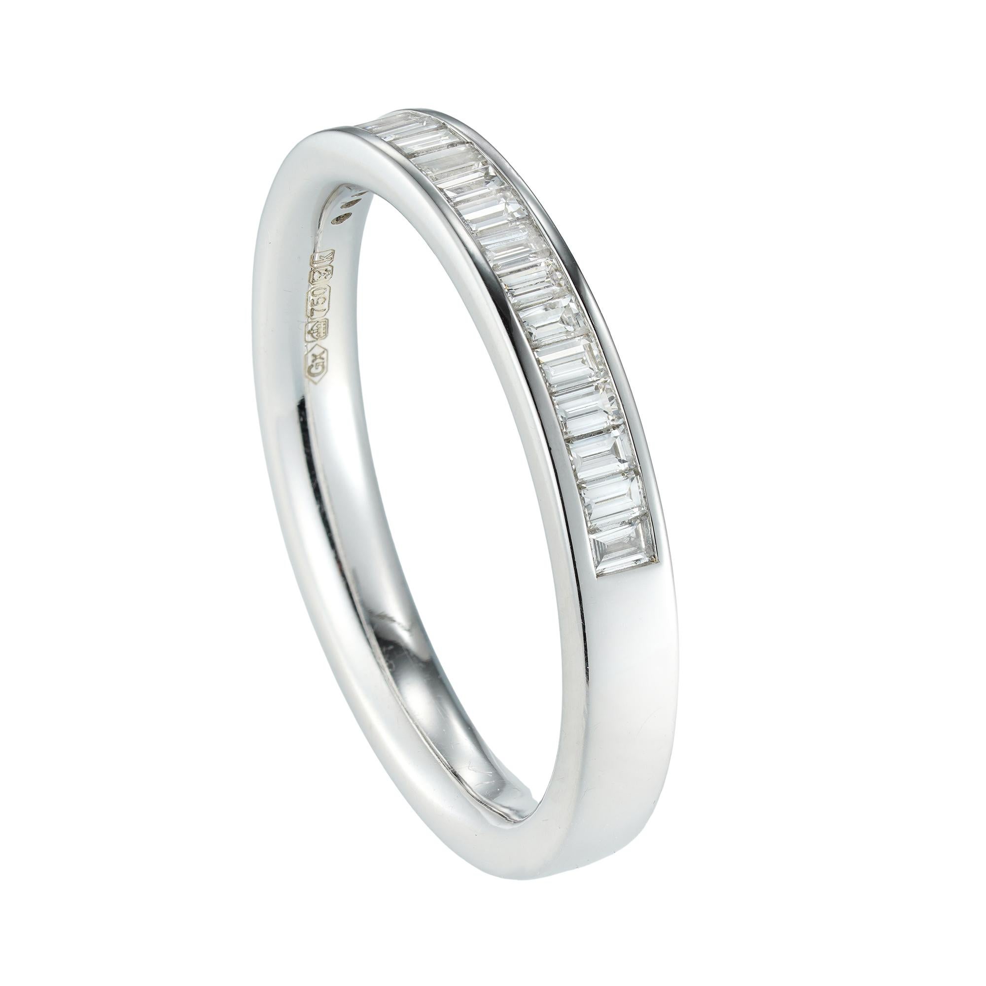 A baguette-cut diamond half eternity ring, set with nineteen baguet-cut diamonds weighing 0.33 carats in total, all channel-set in white gold mount, hallmarked 18ct gold, London 2009, measuring 3mm wide, finger size M, gross weight 3.6 grams.

This