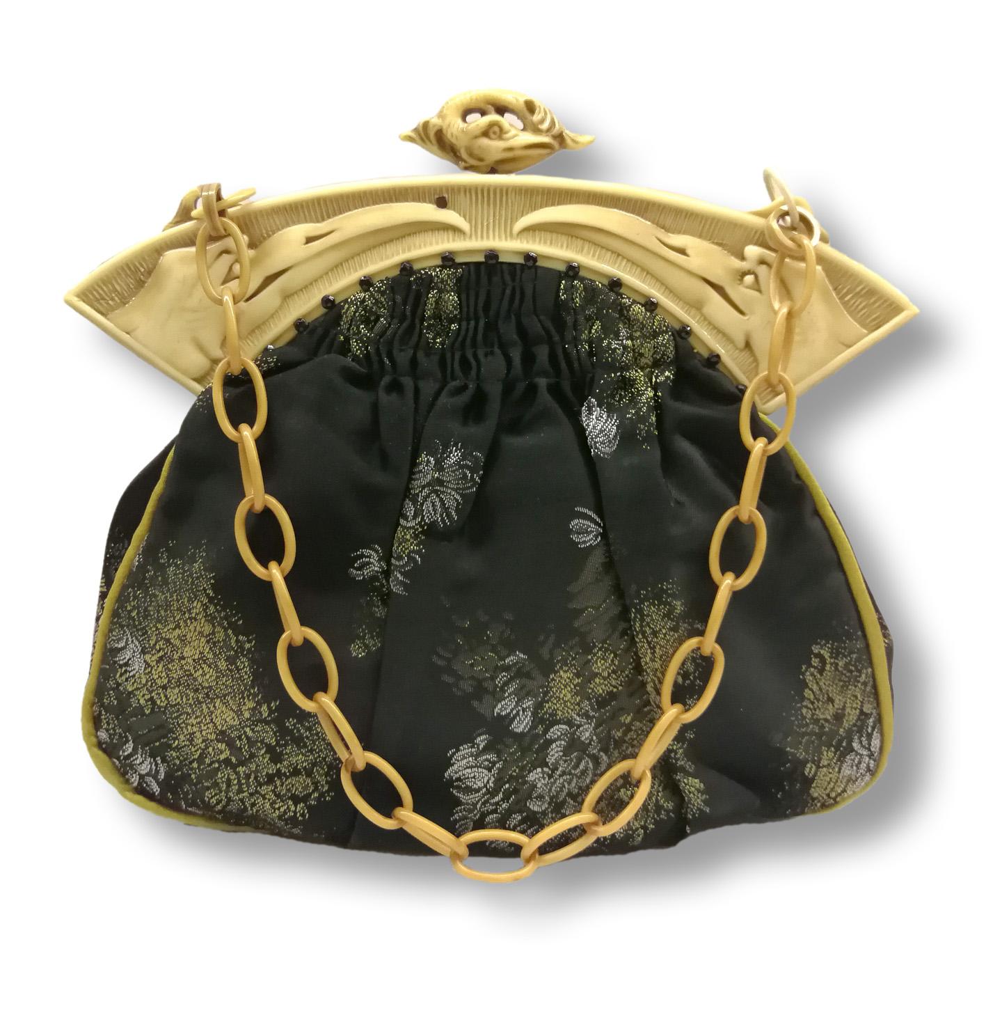 An exquisite handbag. Using an original 1920s French celluloid frame, a beautiful crafted handbag of original black patterned silk has been made anew for the bag. The frame imitates carved ivory (as did many early celluloid/Bakelite pieces from the