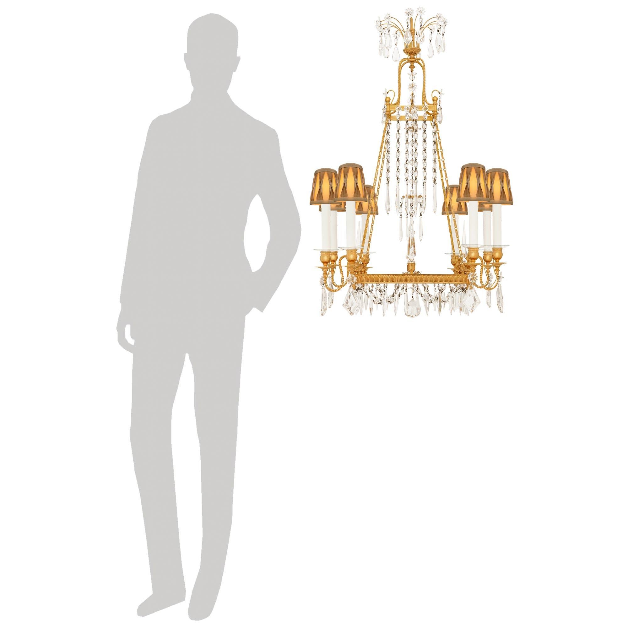 An elegant and high quality Baltic 19th century Neo-Classical st. Ormolu and Crystal chandelier. This most unique eight light chandelier displays a square shaped Ormolu open cage with outer palmette designs. At the four corners of the square frame