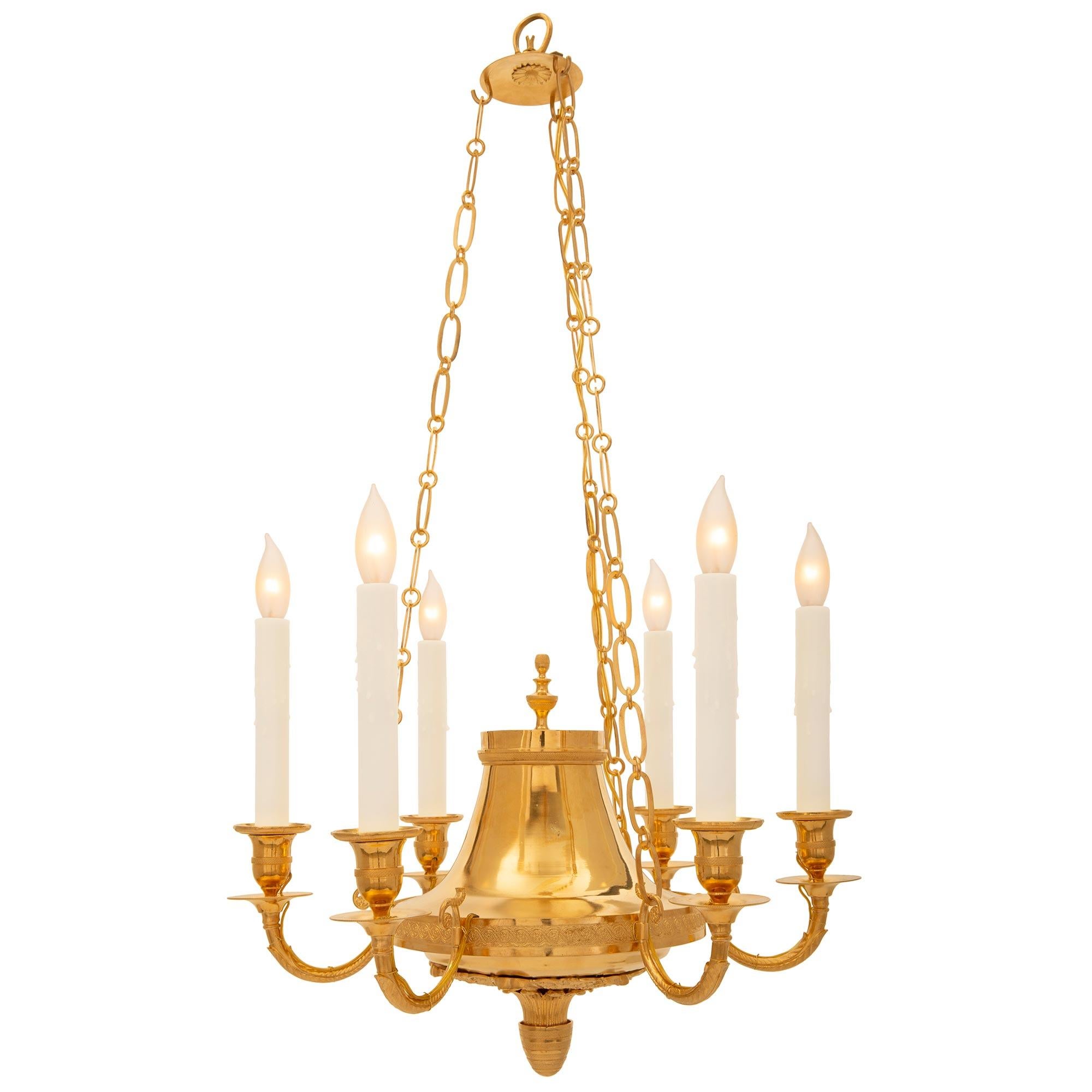 A beautiful Baltic early 19th century Neo-Classical st. ormolu chandelier. The six arm chandelier is centered by an elegant and unique bottom finial with finely etched wrap around bands below lovely richly chased scrolled foliate and palmette