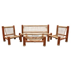 Ein Bambus- und Seil-Set, bestehend aus einem großen Sofa, zwei Sesseln und einem Couchtisch.