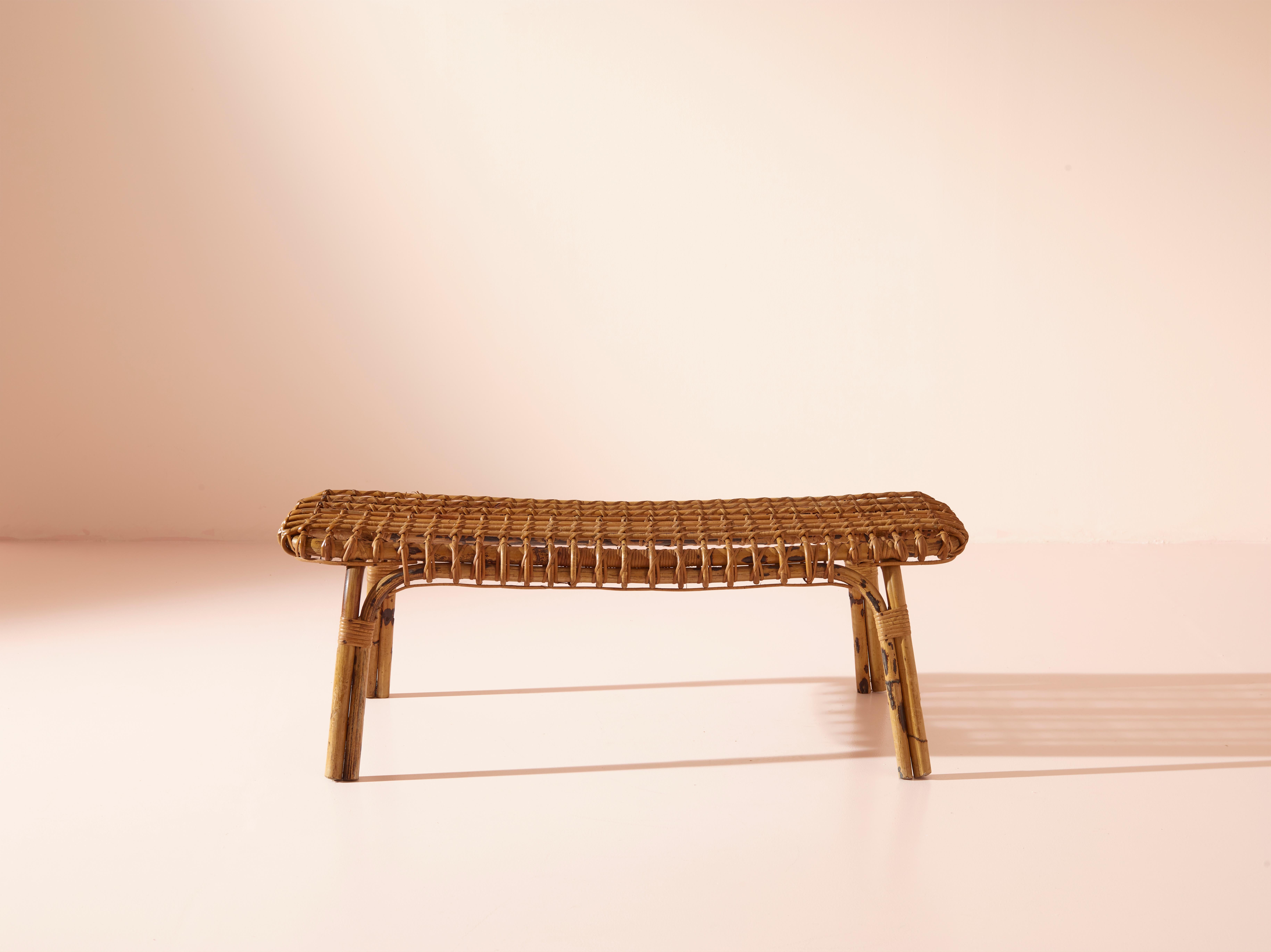 This exquisite bamboo bench originating from 1960s has been produced in Italy and attributed to the renowned furniture maker Vittorio Bonacina. 

The bamboo construction of the bench exhibits a captivating lattice pattern on the seat, elevating