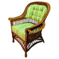 A Bar Harbor Style Wicker Arm Chair with Magazine Pocket