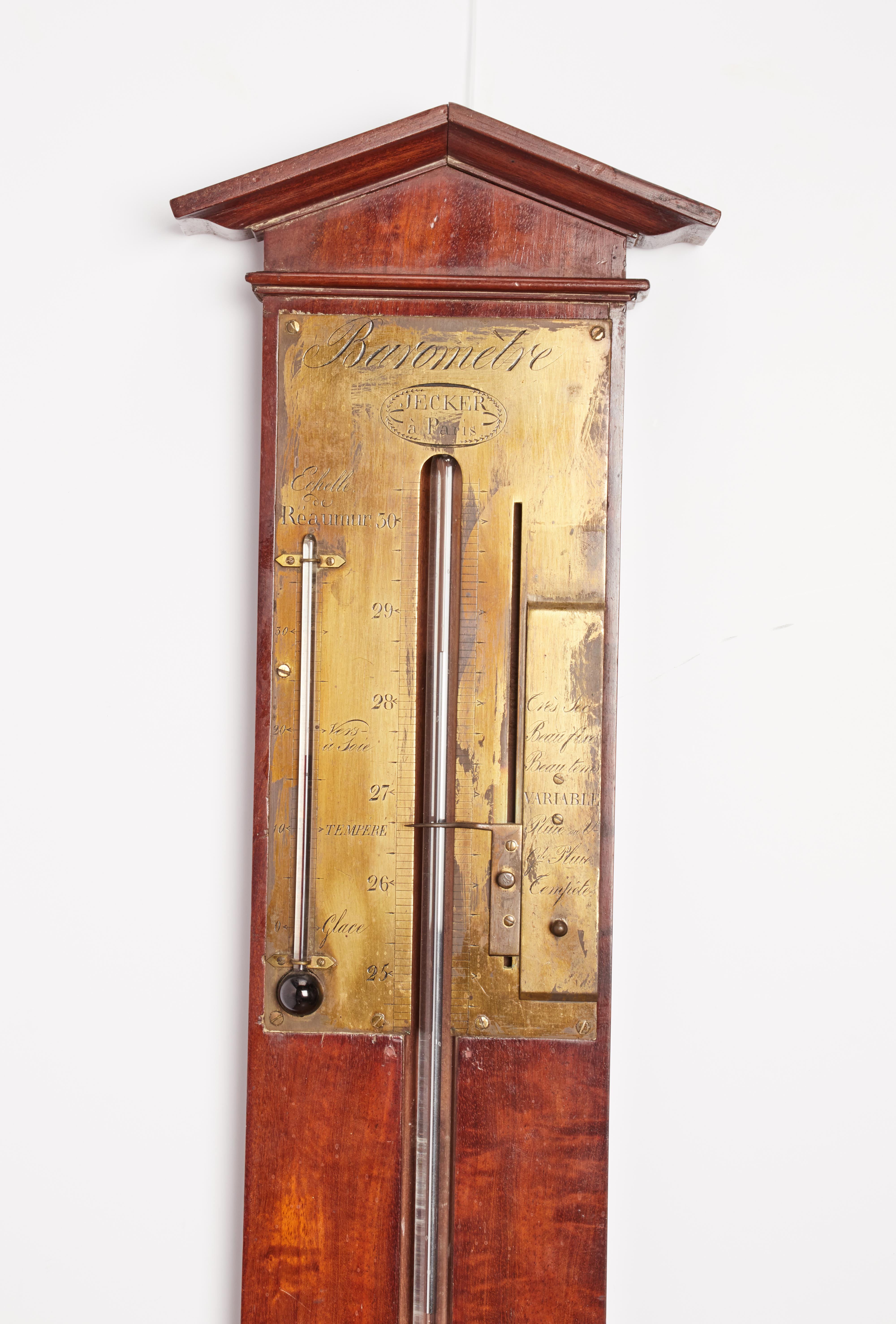 Mahogany wall barometer consisting of a glass tube containing mercury with its reserve.
On the top part a chevron shaped pediment and a screwed brass plate with a small alcohol thermometer and a mobile brass index for the barometer.
The brass