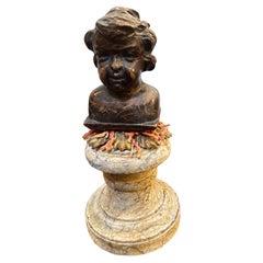 A Baroque Revival Wood Bust of a Putto on a fake Marble Lacquered Wood Base