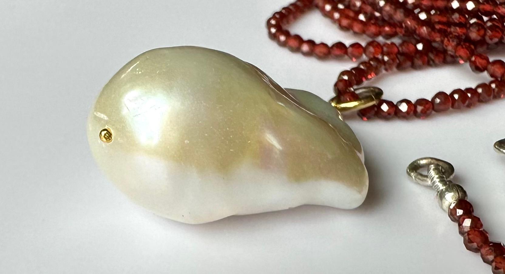 A Baroque South Sea Pearl Pendant hanging from a 24 Inch Beaded Garnet Necklace For Sale 5