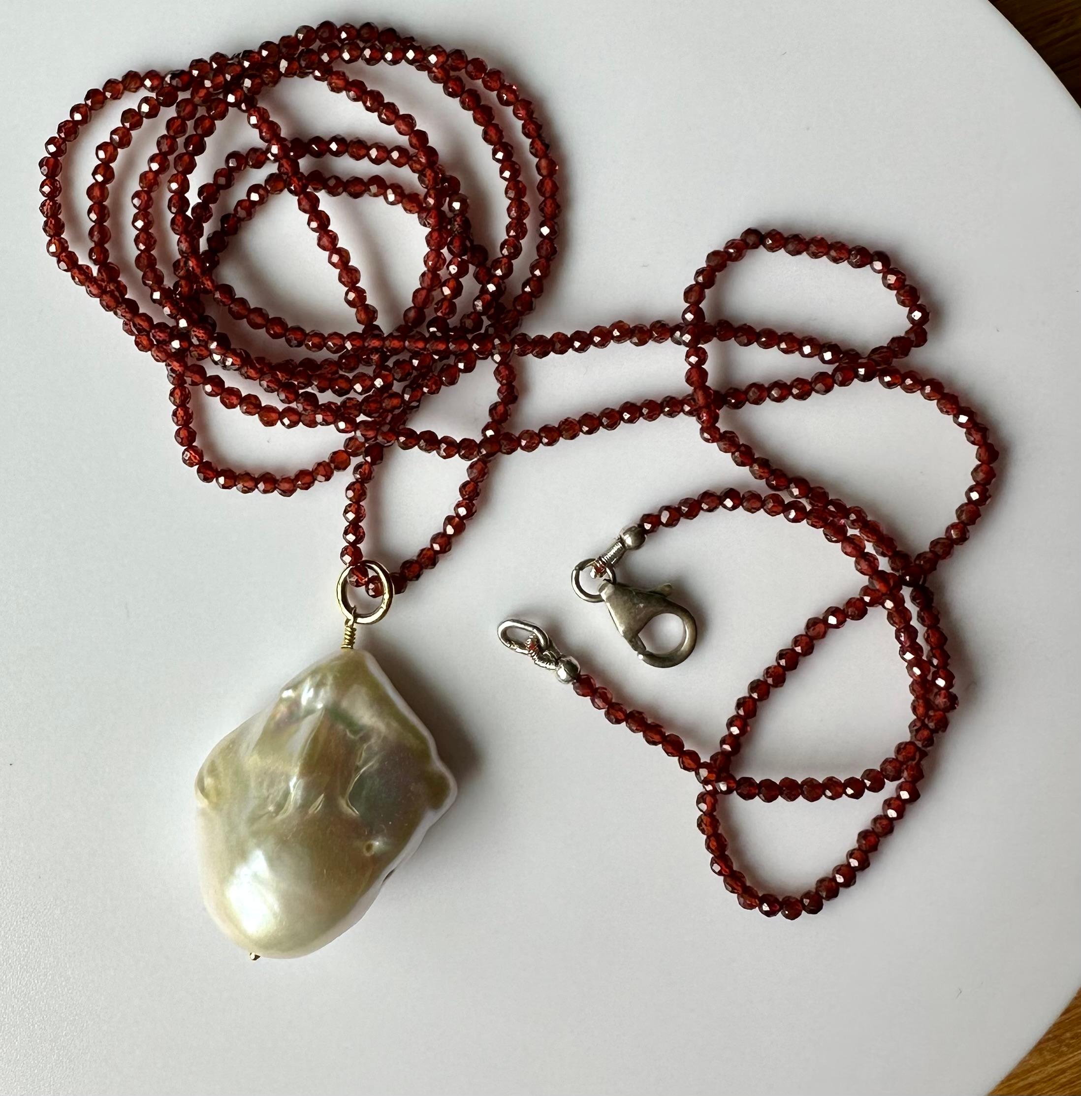 Rough Cut A Baroque South Sea Pearl Pendant hanging from a 24 Inch Beaded Garnet Necklace For Sale