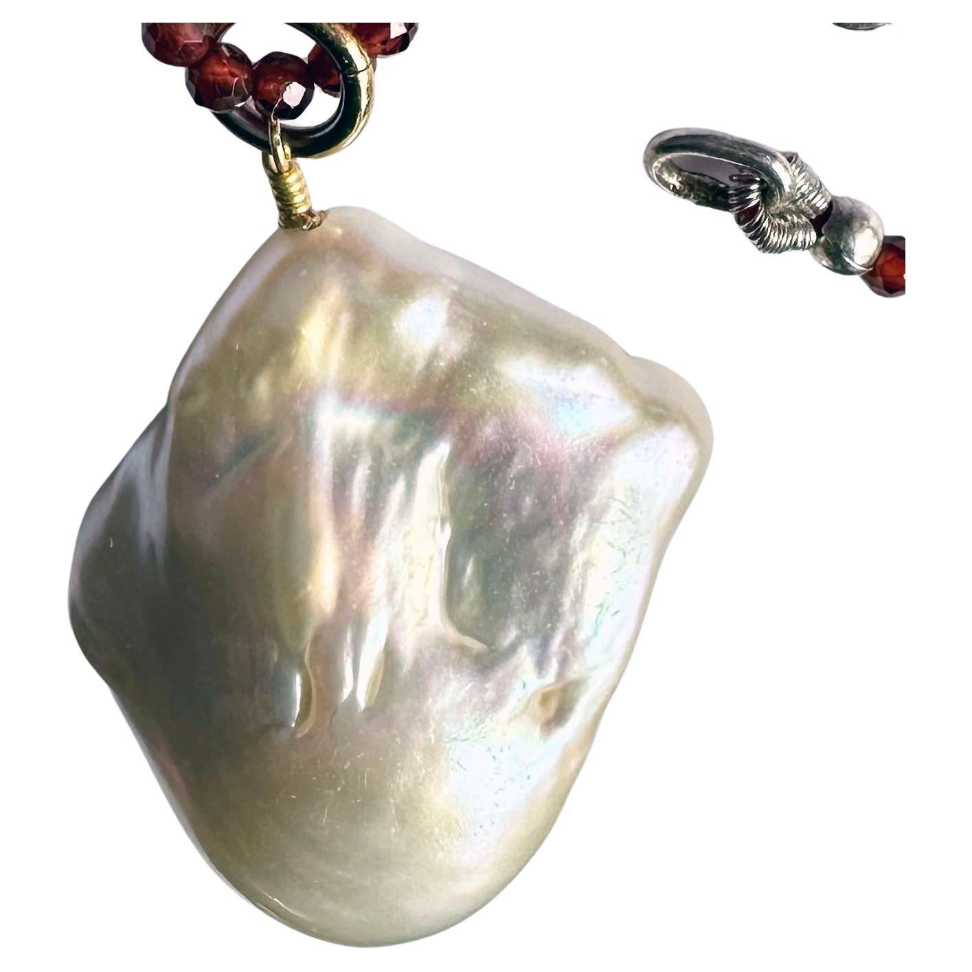 A Baroque South Sea Pearl Pendant hanging from a 24 Inch Beaded Garnet Necklace For Sale