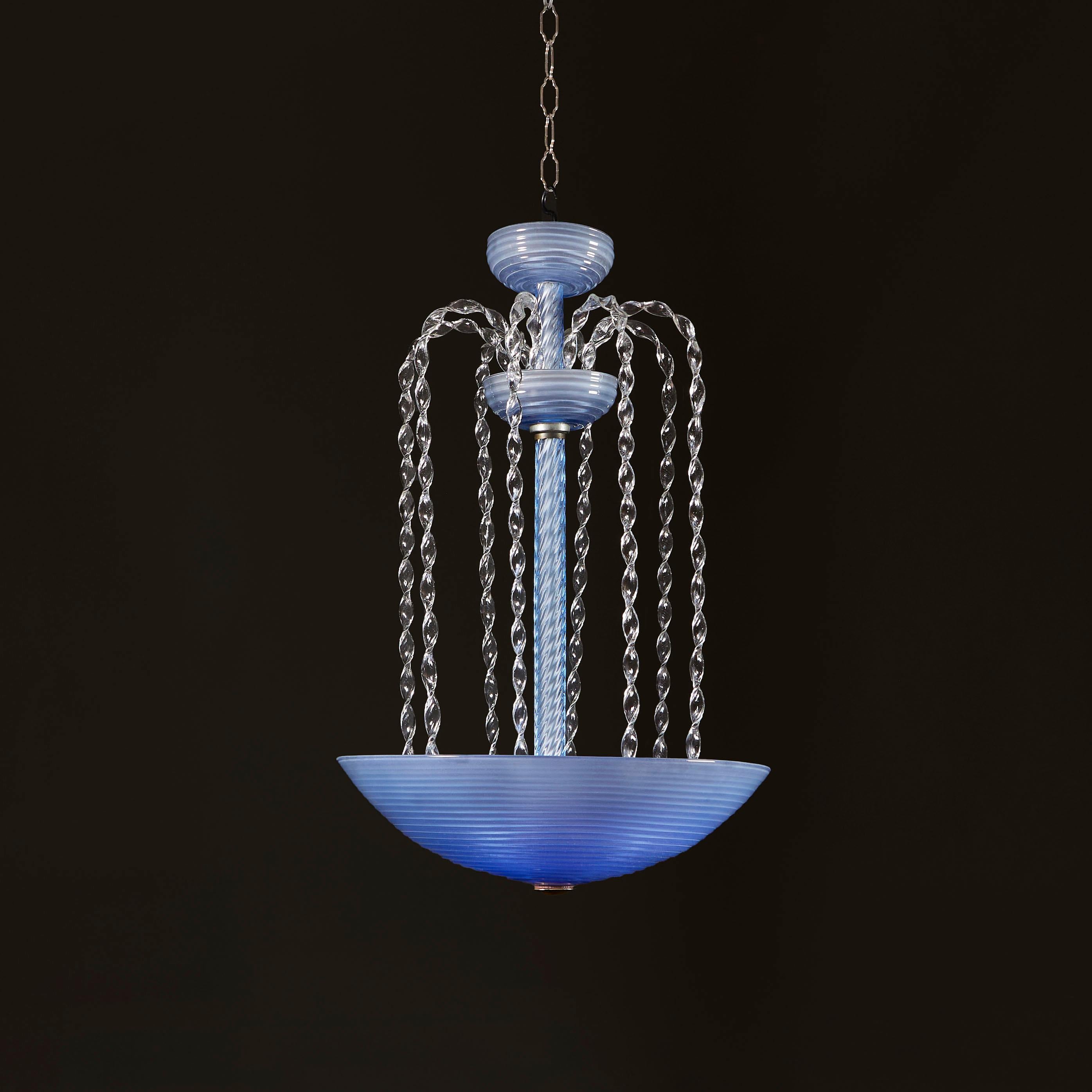 Italy, circa 1940

A mid twentieth century blue glass waterfall hanging light attributed to Barovier & Toso, the spiral glass stem with two smaller dishes to the top, with eight twisted spiral glass rods falling into a larger ribbed dish at the